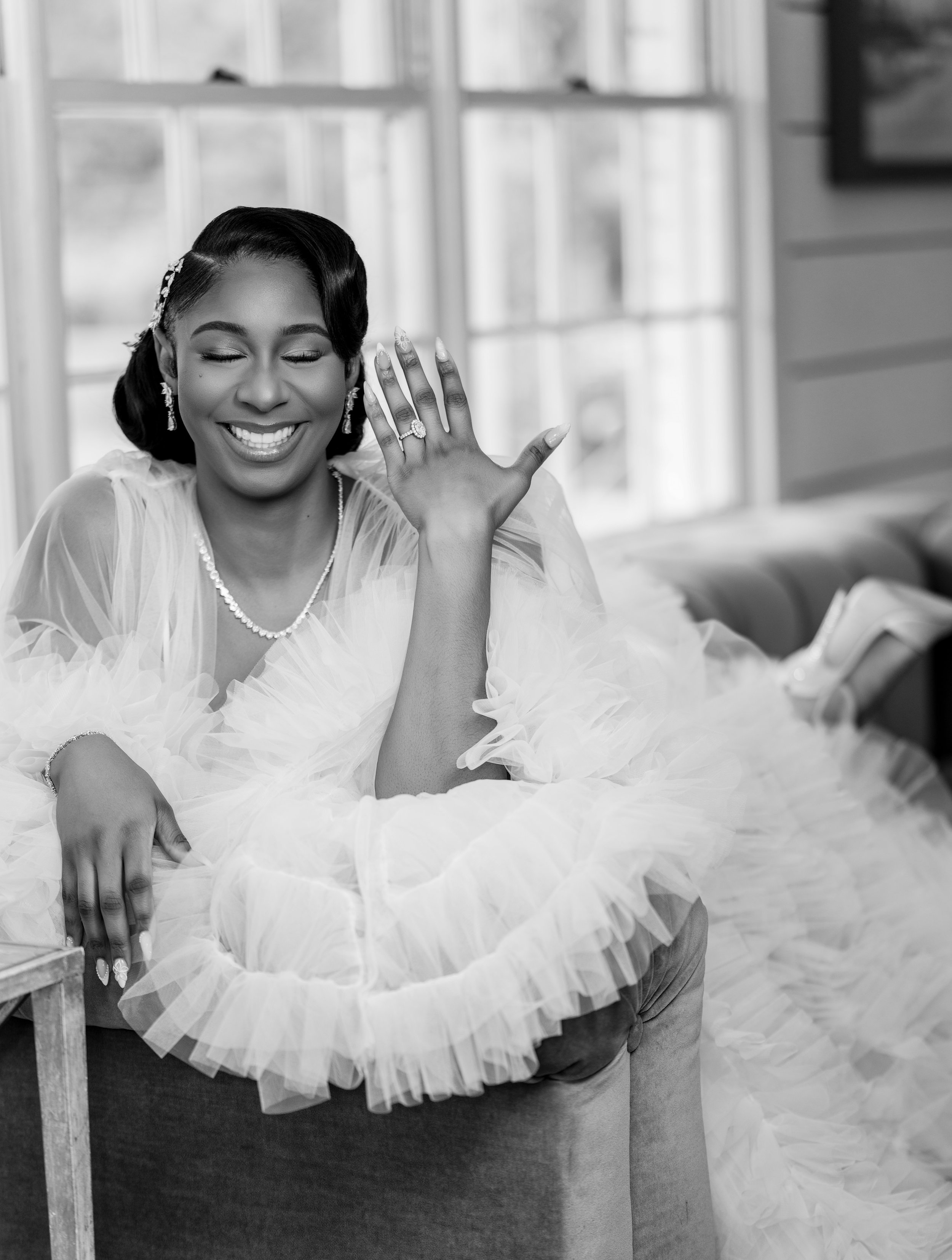 Bride smiling and showing her wedding ring while getting ready at The Venue at Daisy Hill.