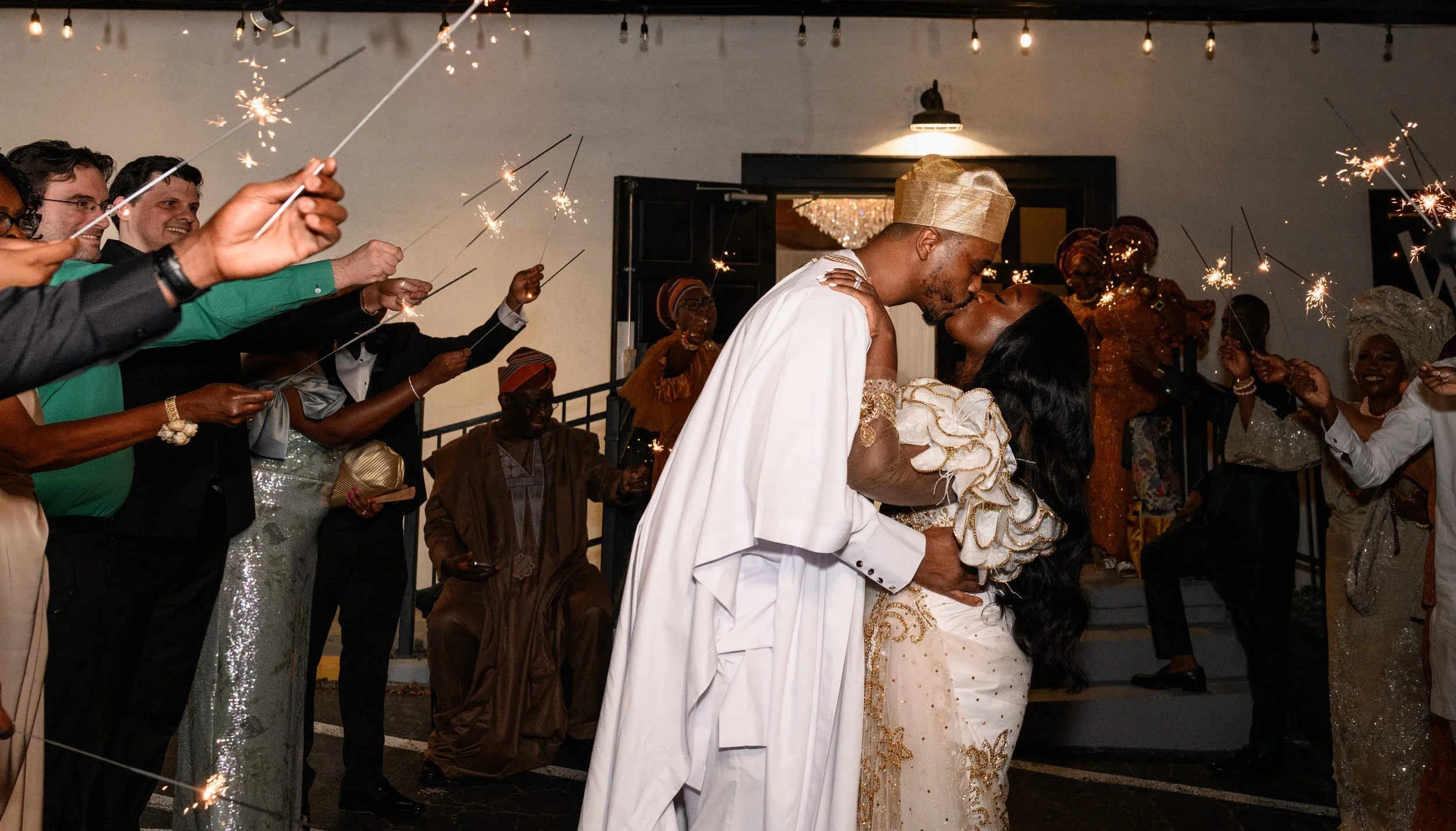 Jalisa and Sadiq kissing beneath sparklers during their wedding celebration at The West Venue