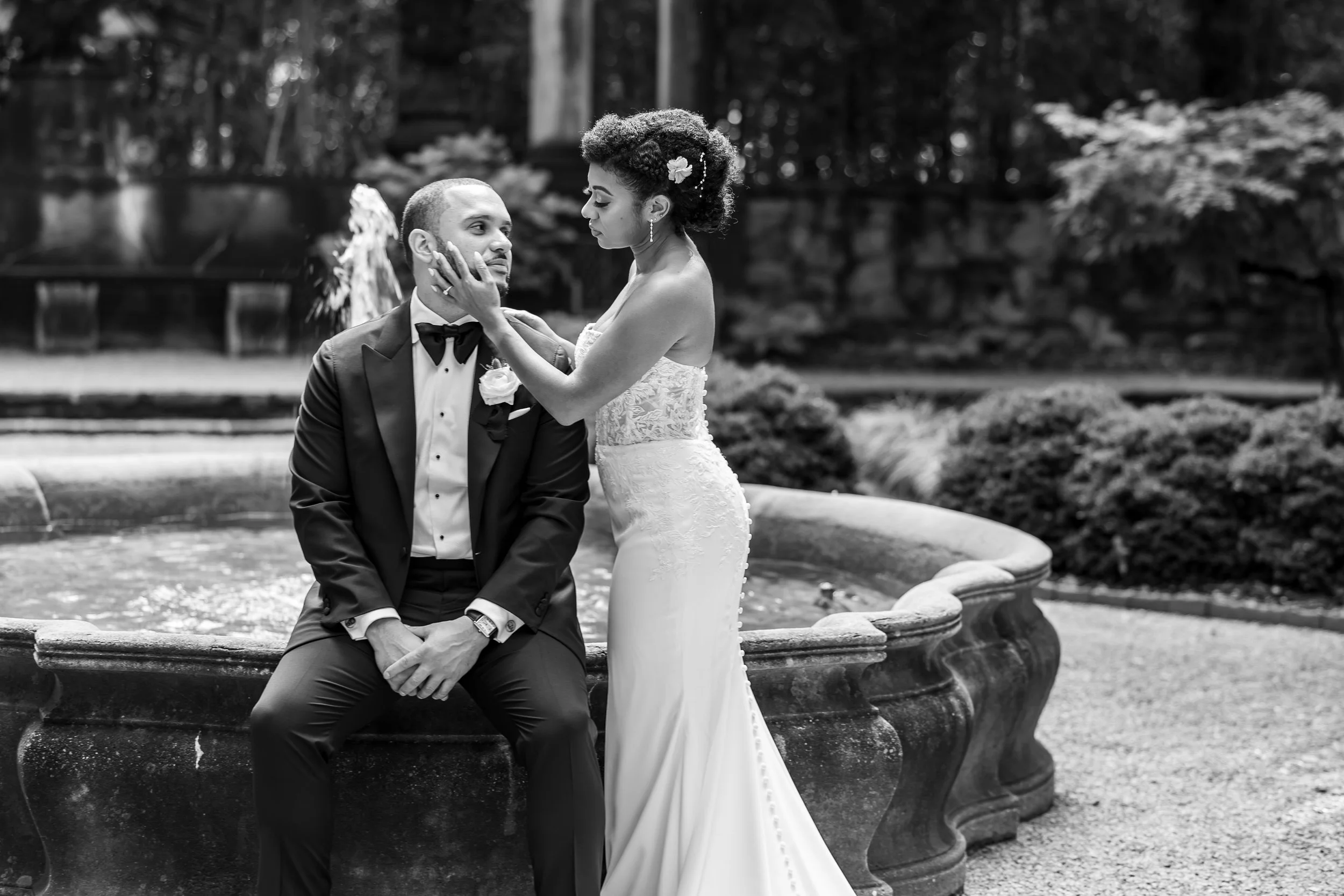 Bride gently holds the groom's face during their wedding portrait at the Swan House in Atlanta, Georgia.