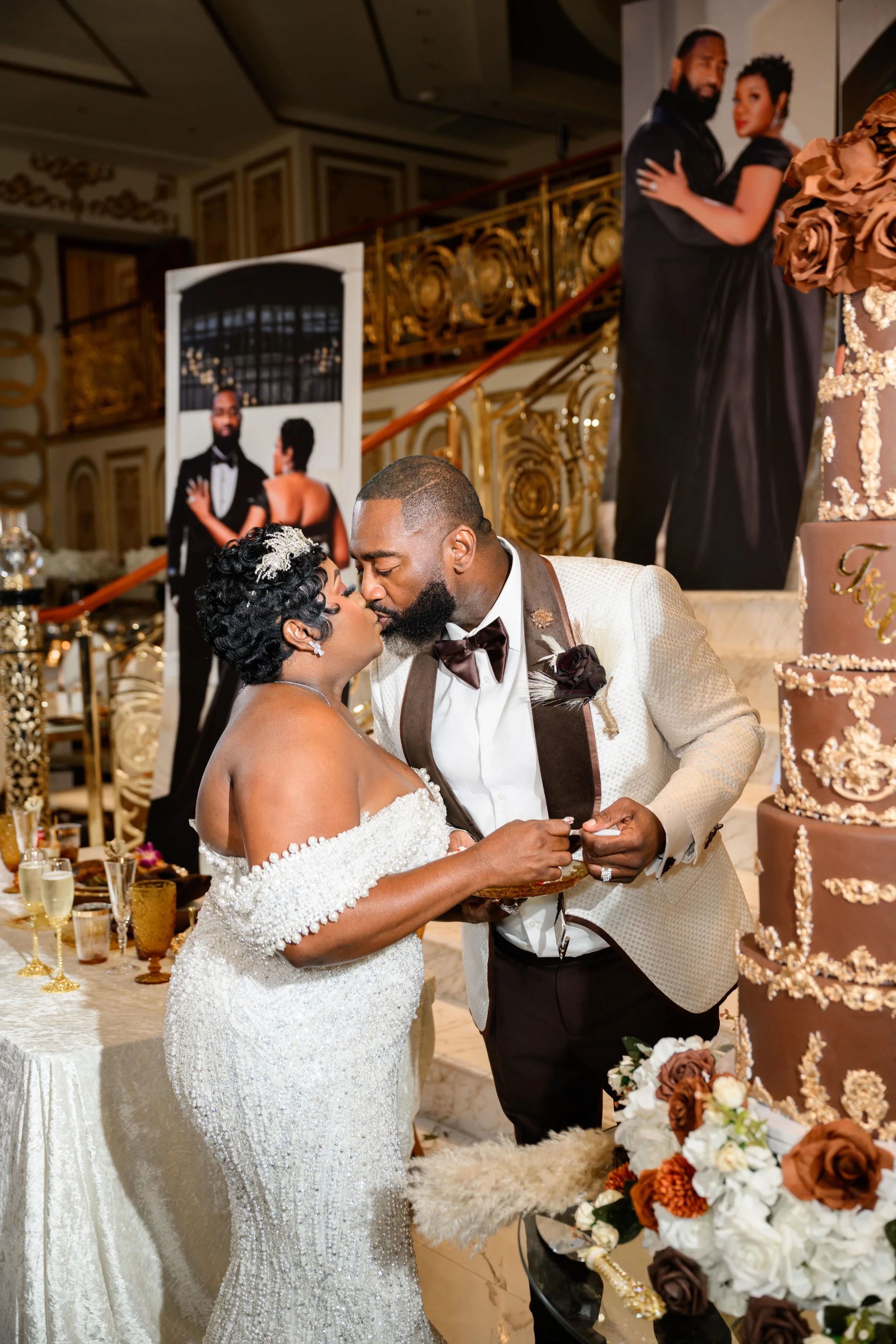 Bride and groom kissing while cutting their wedding cake during their reception at Shahbain Events Center.