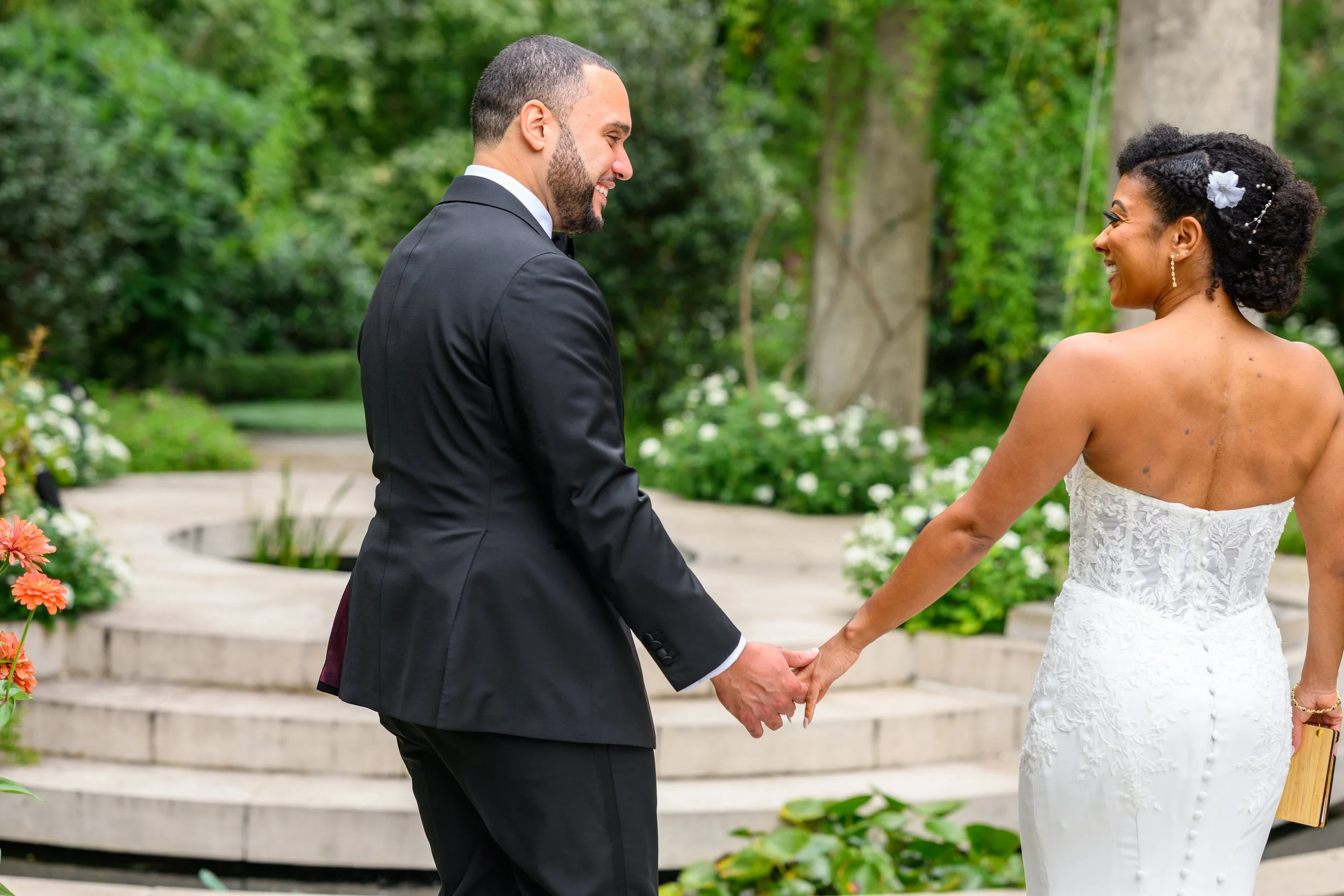 Bride and groom holding hands during their Atlanta wedding photographed by Crystal Artis Photography