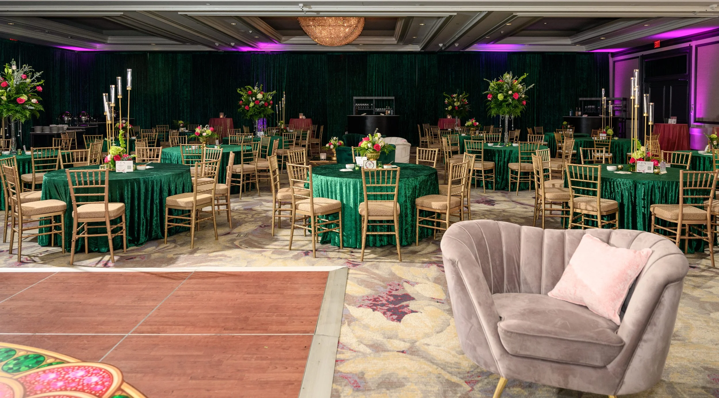 Emerald green tables, gold chairs and floral décor inside The Whitley Hotel for the Sister Friend Circle event.