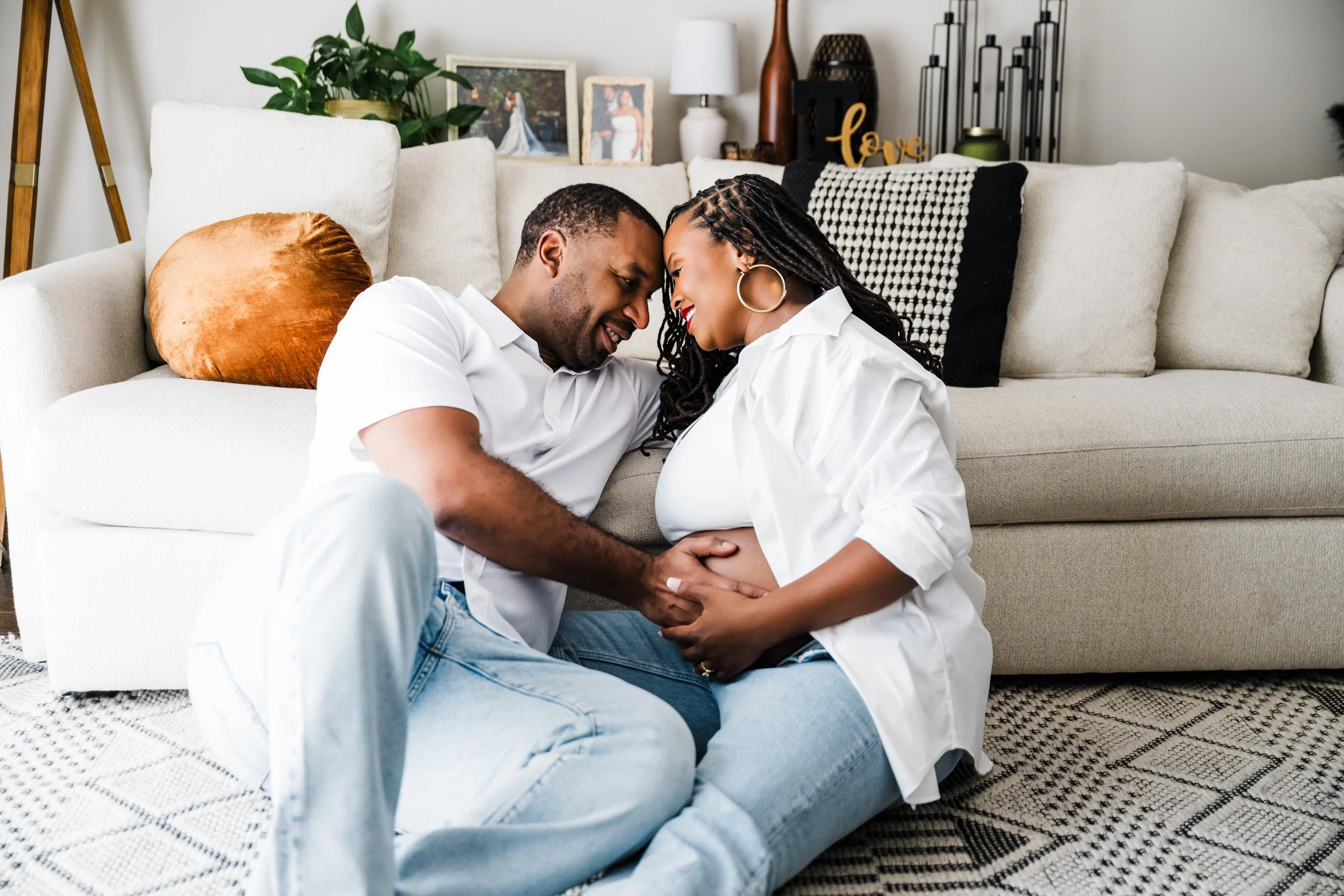 Expecting couple sharing a quiet moment during an in-home maternity session in the Atlanta area.