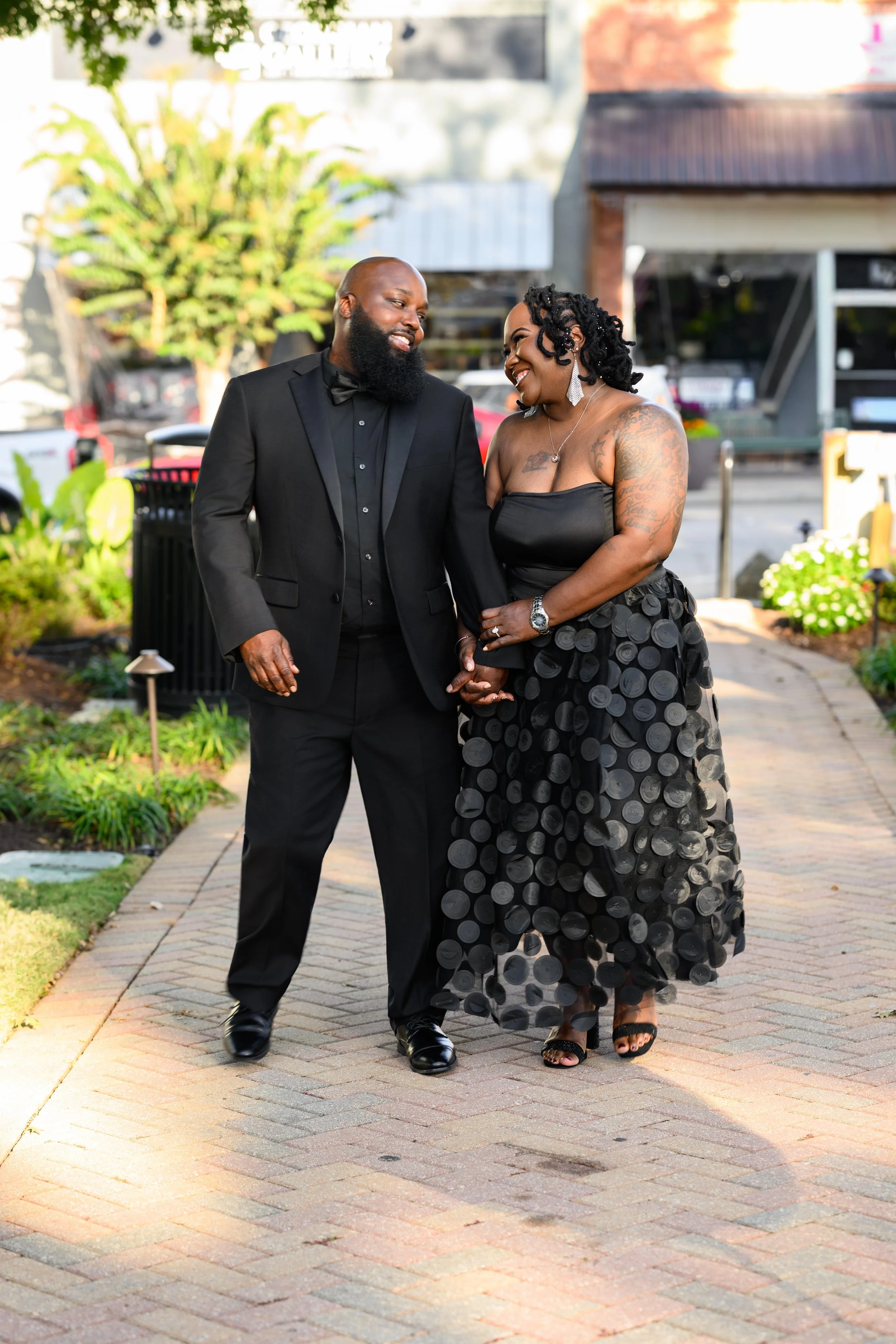 Couple walking together during a portrait session at McDonough Square in downtown McDonough, Georgia.