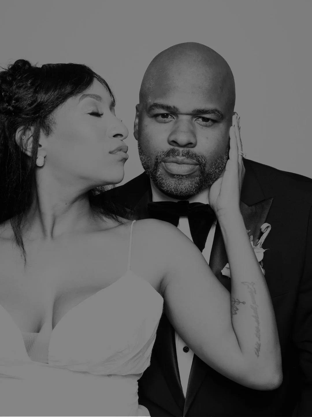 Guests having fun in a black-and-white Glam Photo Booth at an Atlanta event by The Artis Touch Photo Booth.