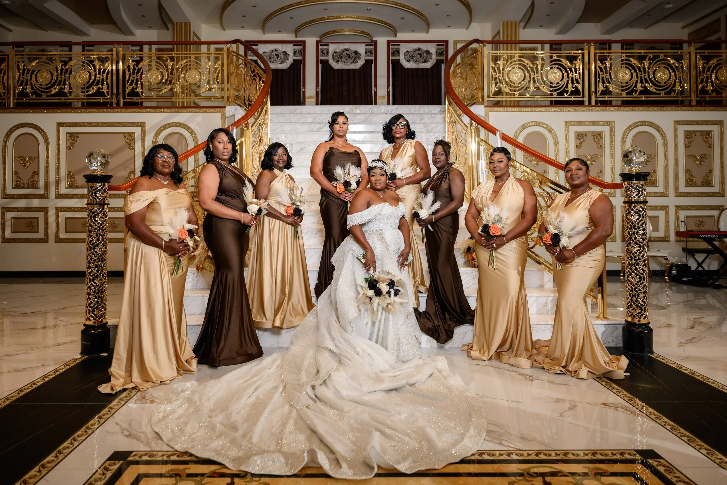 Bride surrounded by her bridesmaids on the staircase at Shahbain Events Center in North Carolina.