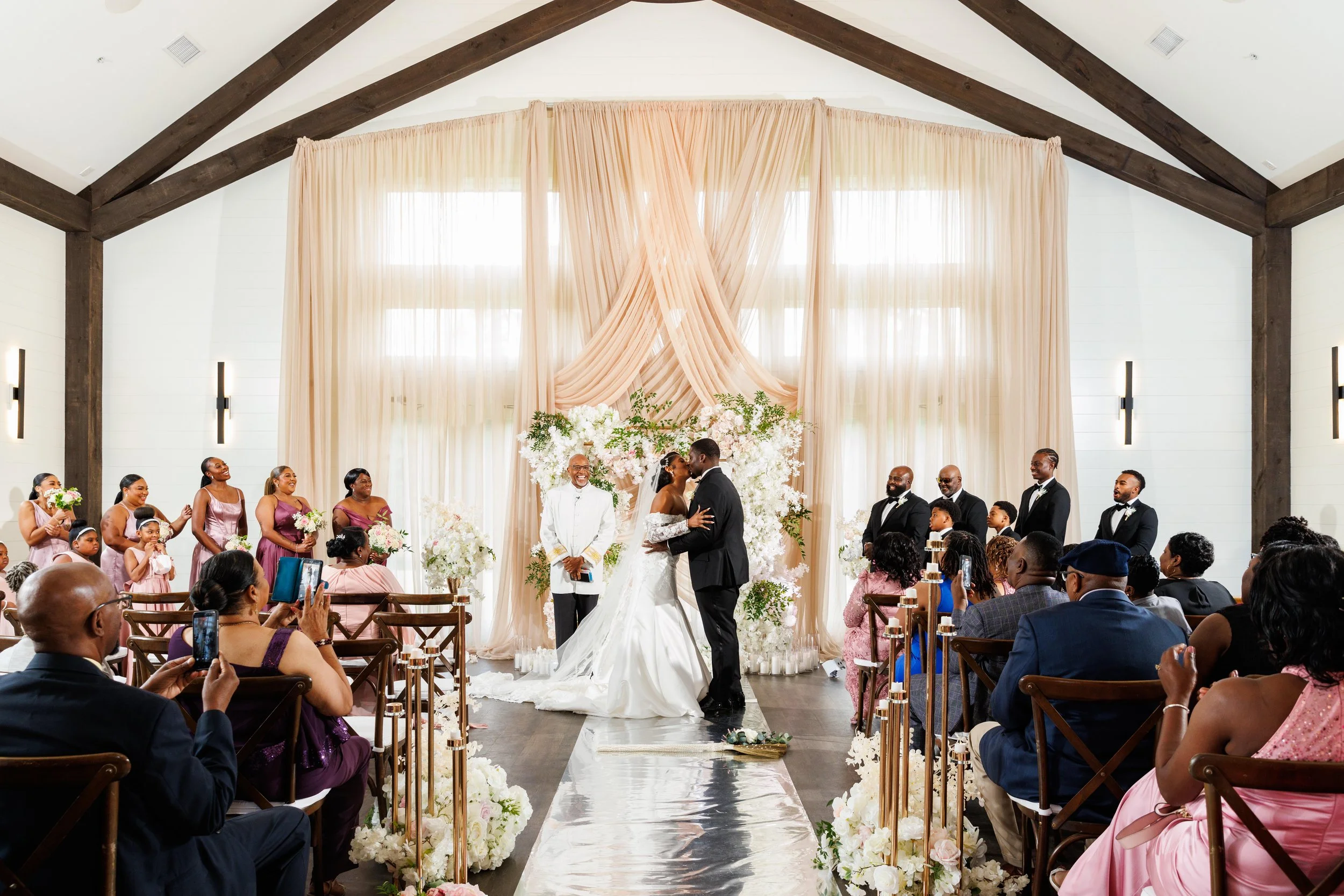 Bride and groom sharing their first kiss during their wedding ceremony at The Venue at Daisy Hill.