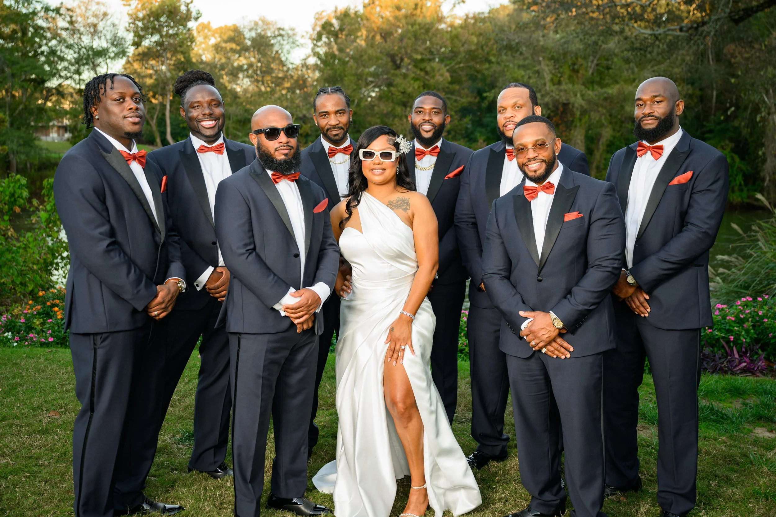 Bride standing confidently with groomsmen during Ashley and Jason’s intimate wedding at Canoe Restaurant.