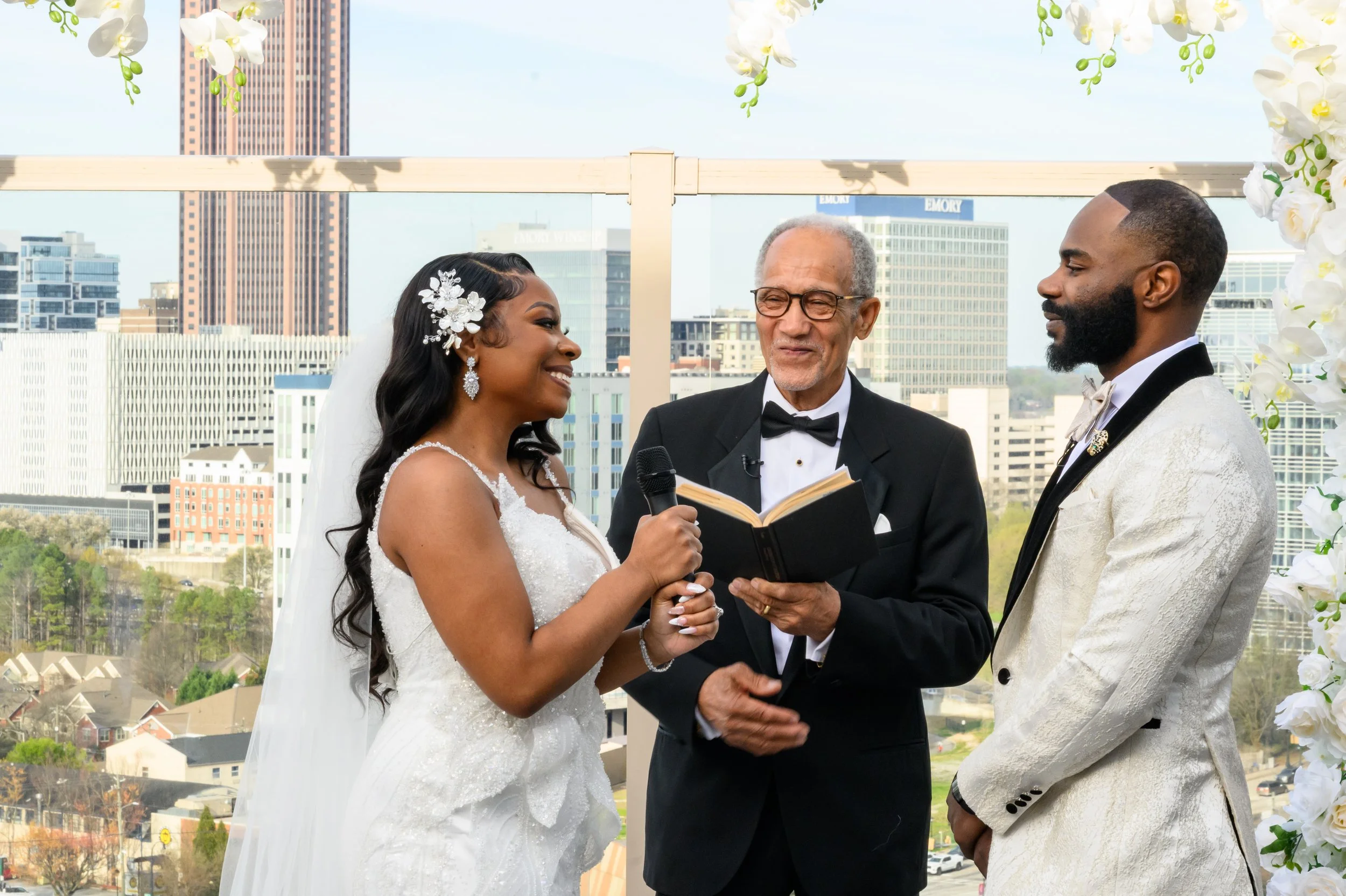 Shareze and Jacorey exchanging vows during their rooftop wedding ceremony at Ventanas in Atlanta.