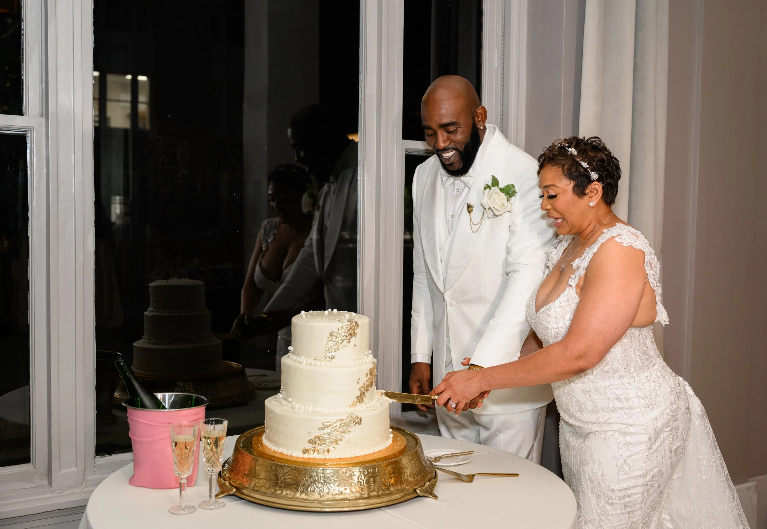 Bride and groom cutting their wedding cake during their Georgian Hall reception.