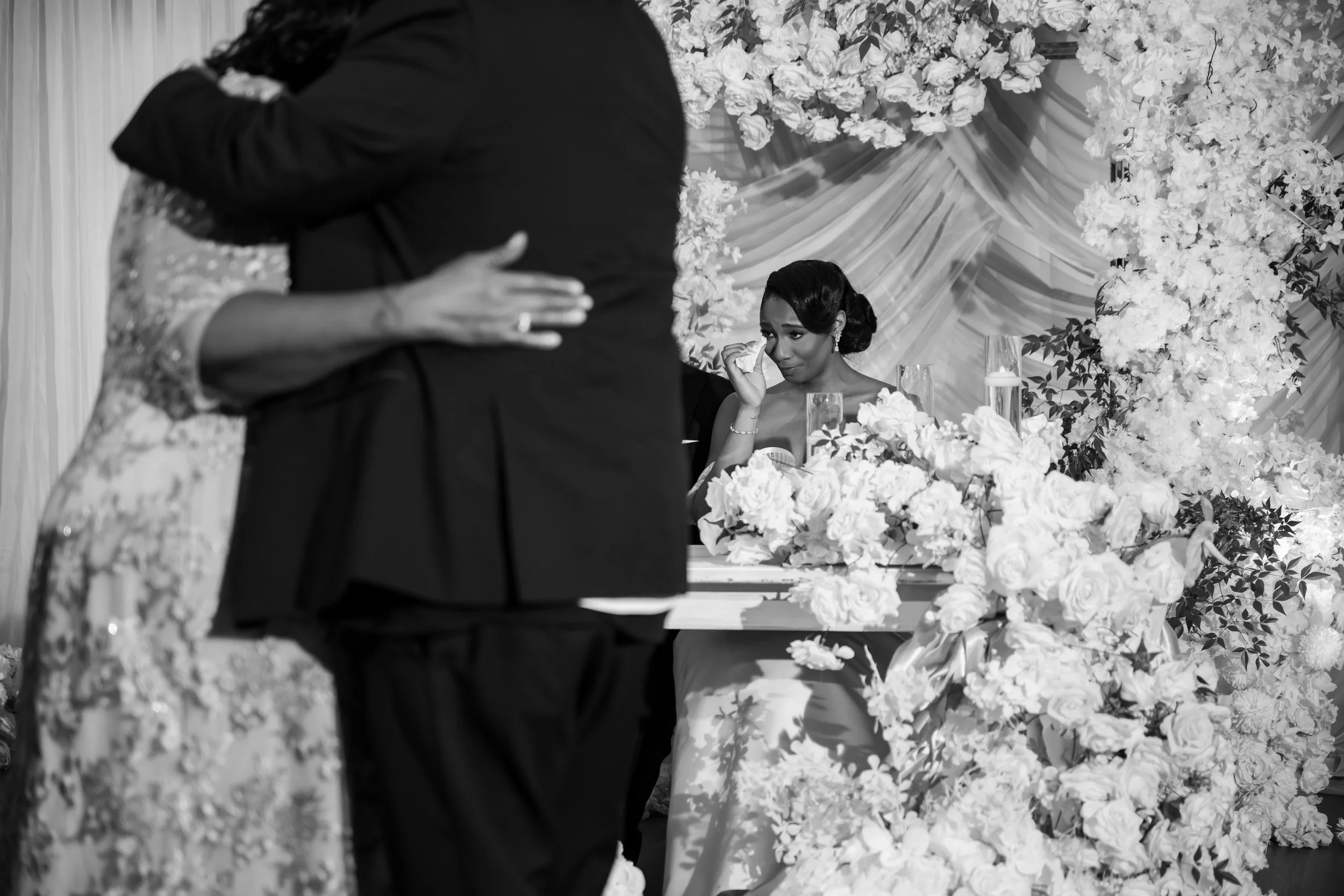 Bride wiping away a tear during an emotional wedding reception moment at The Venue at Daisy Hill.