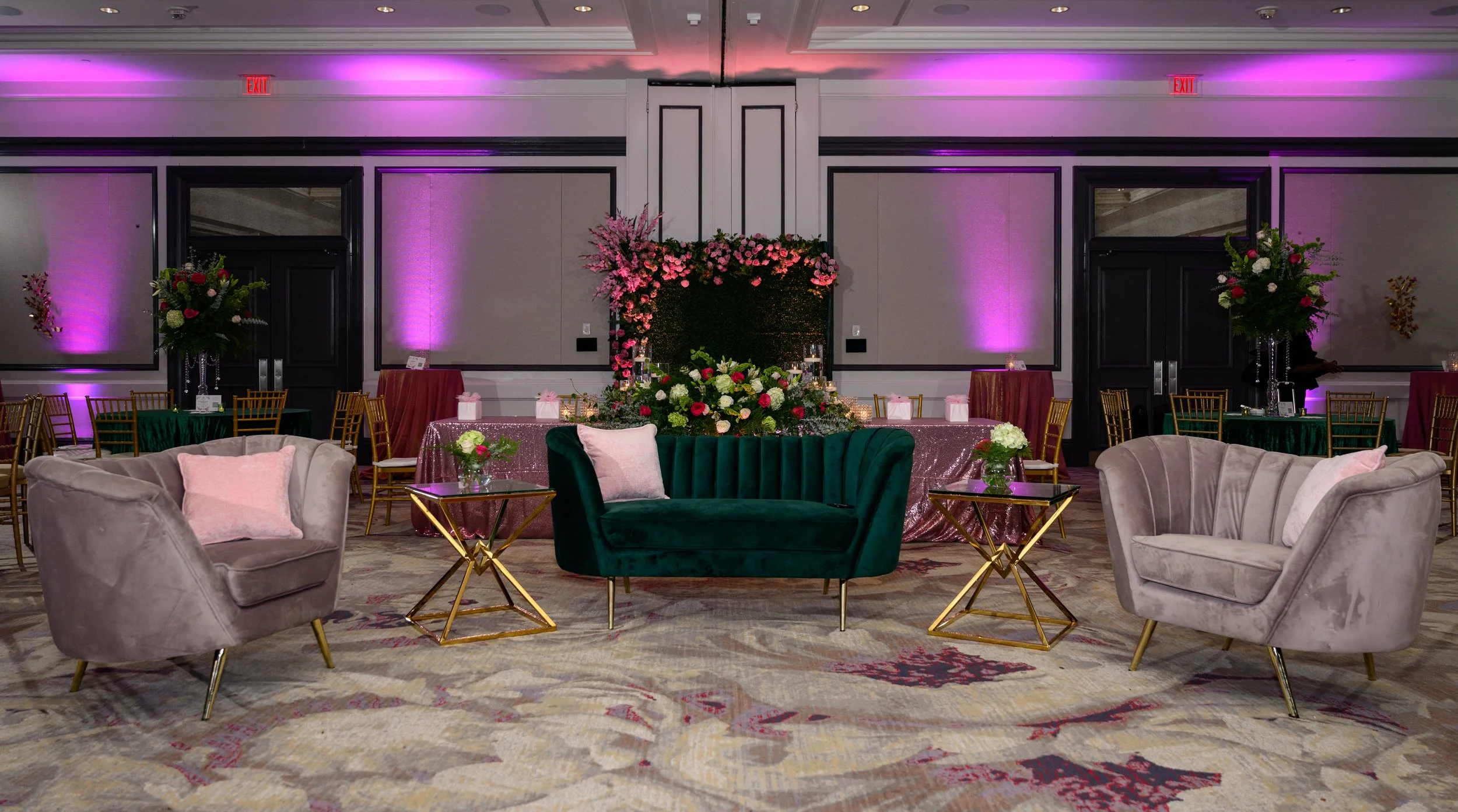 Green velvet lounge seating, florals and event décor at the Sister Friend Circle celebration at The Whitley Hotel.