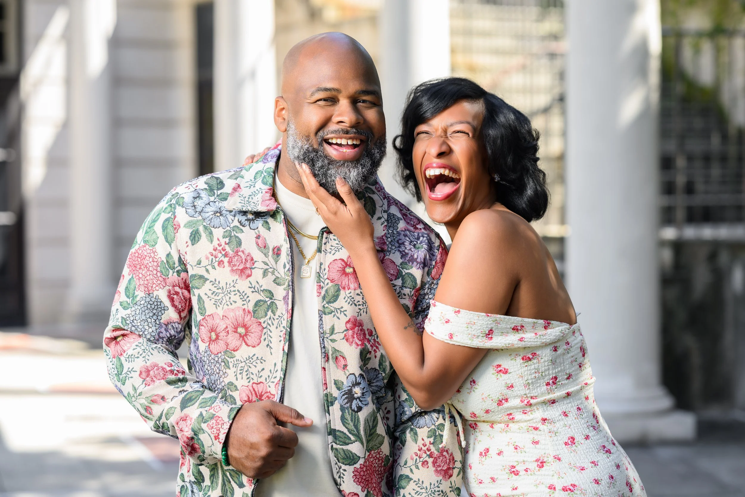 Engaged couple laughing together during a candid portrait at Millennium Gate Museum.