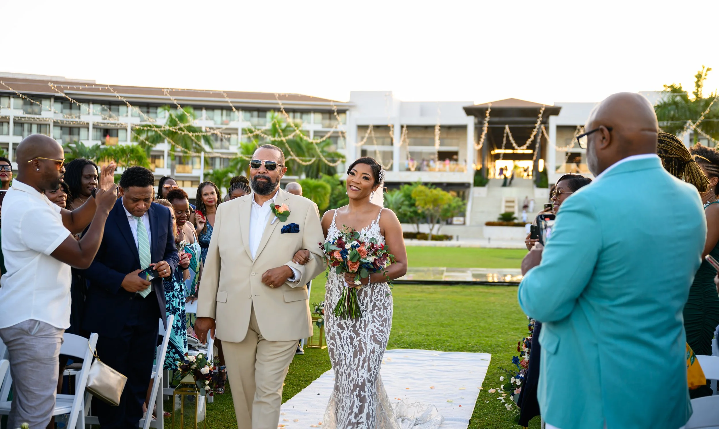 Tekla walking down the aisle during her outdoor destination wedding ceremony in Cancun.