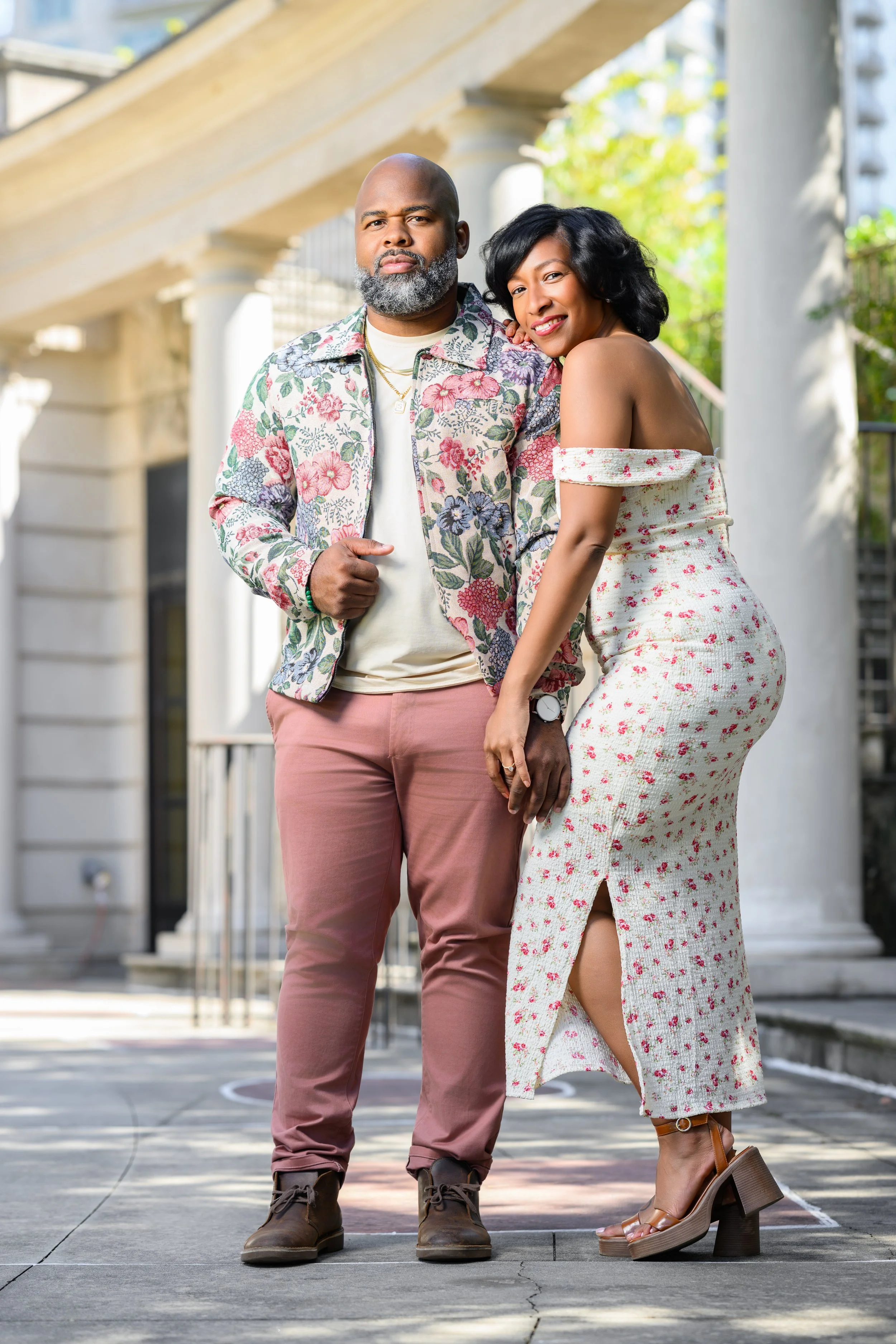 Engaged couple embracing during a romantic portrait session at Millennium Gate Museum.
