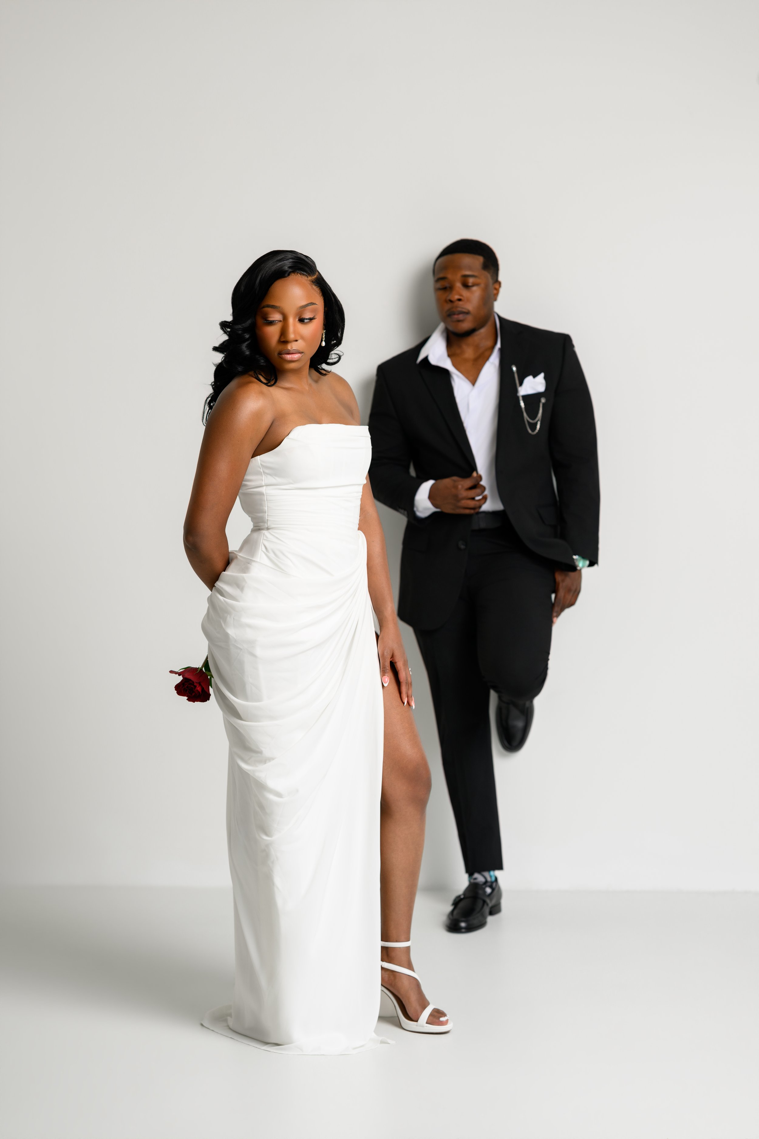 Full-length portrait of Denea and Chris dressed in black and white at Atlanta BeltLine Studio.