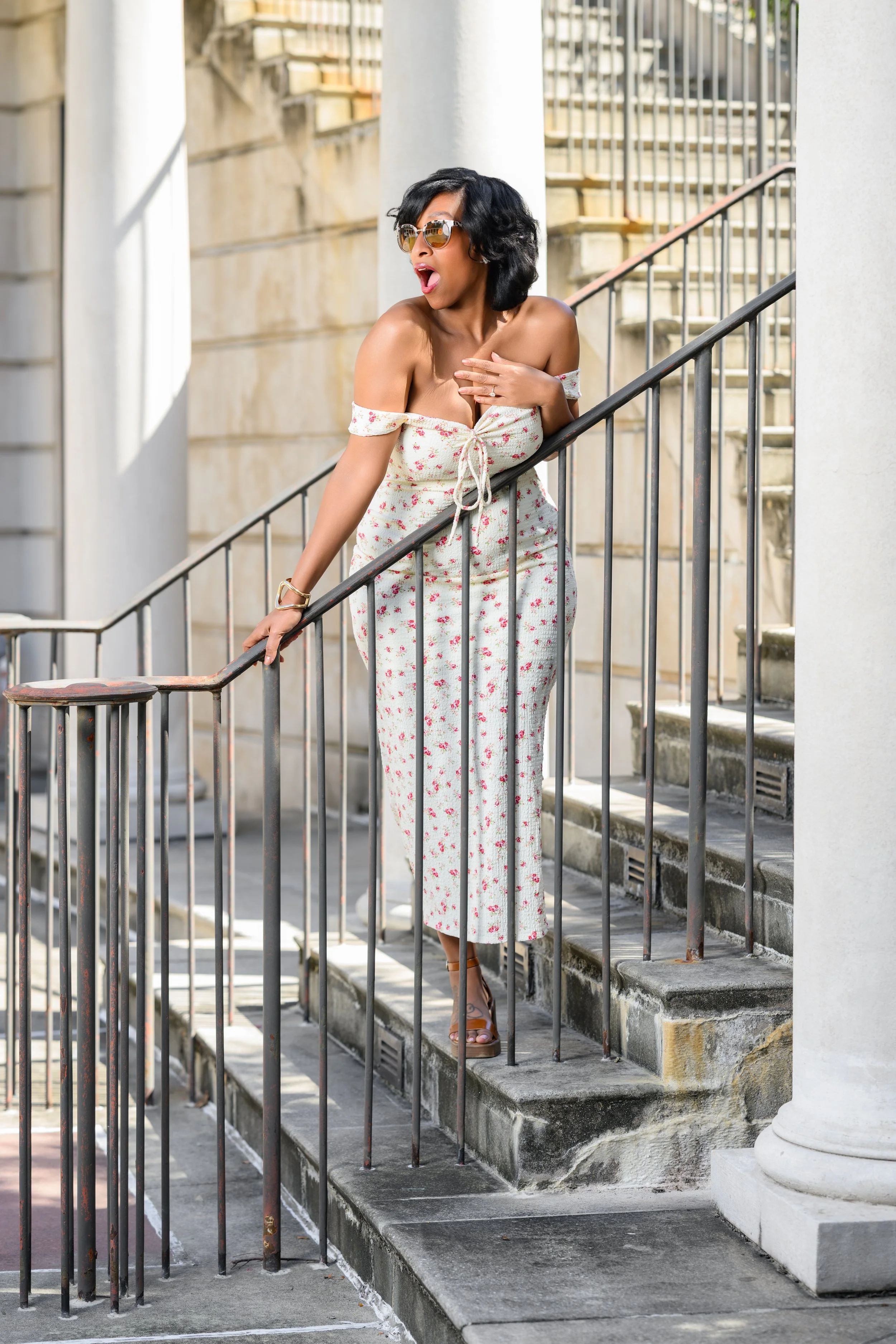 Woman posing on the staircase at Millennium Gate Museum during her Atlanta engagement session.