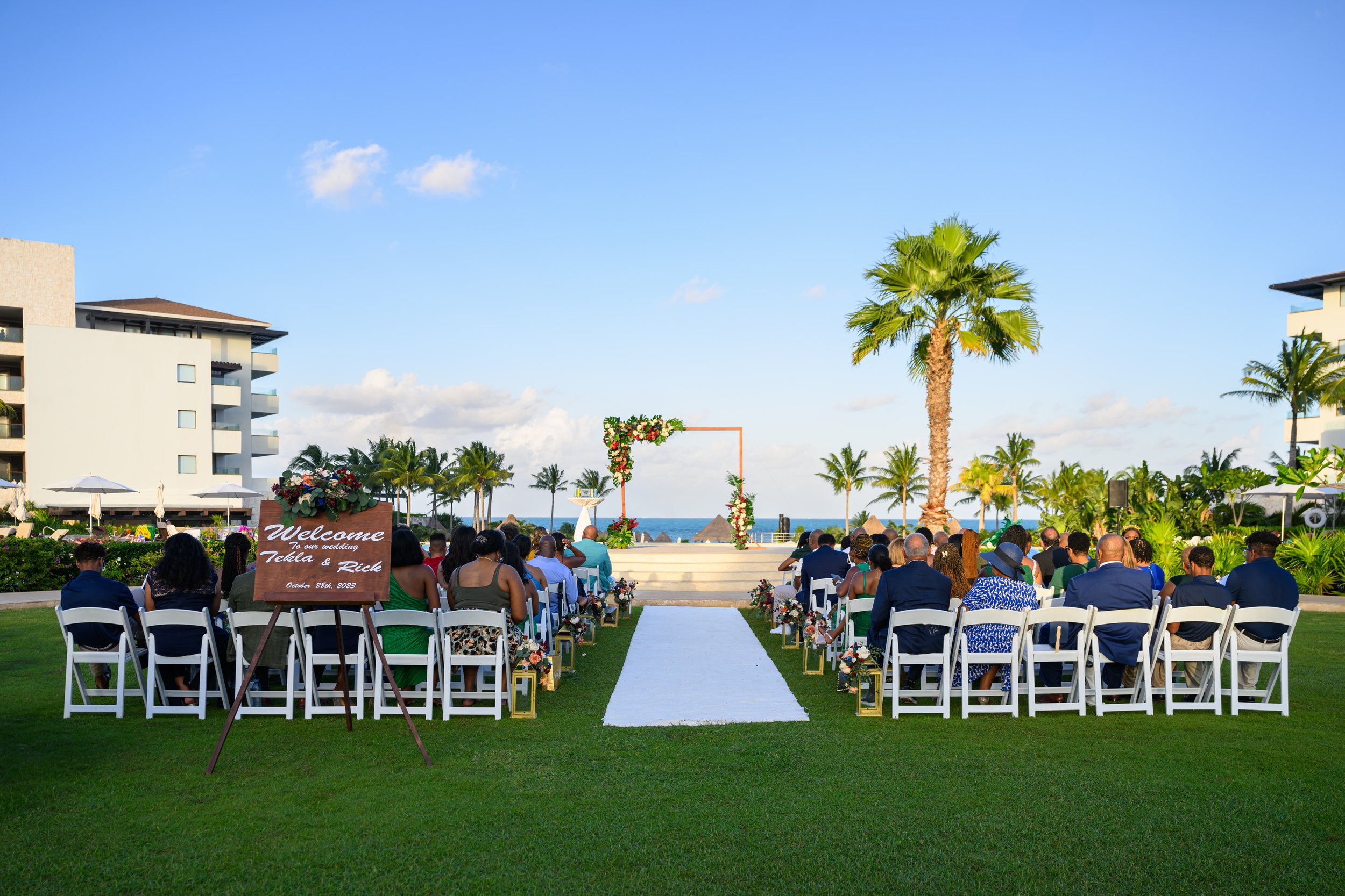 Outdoor destination wedding ceremony overlooking the resort grounds in Cancun, Mexico.