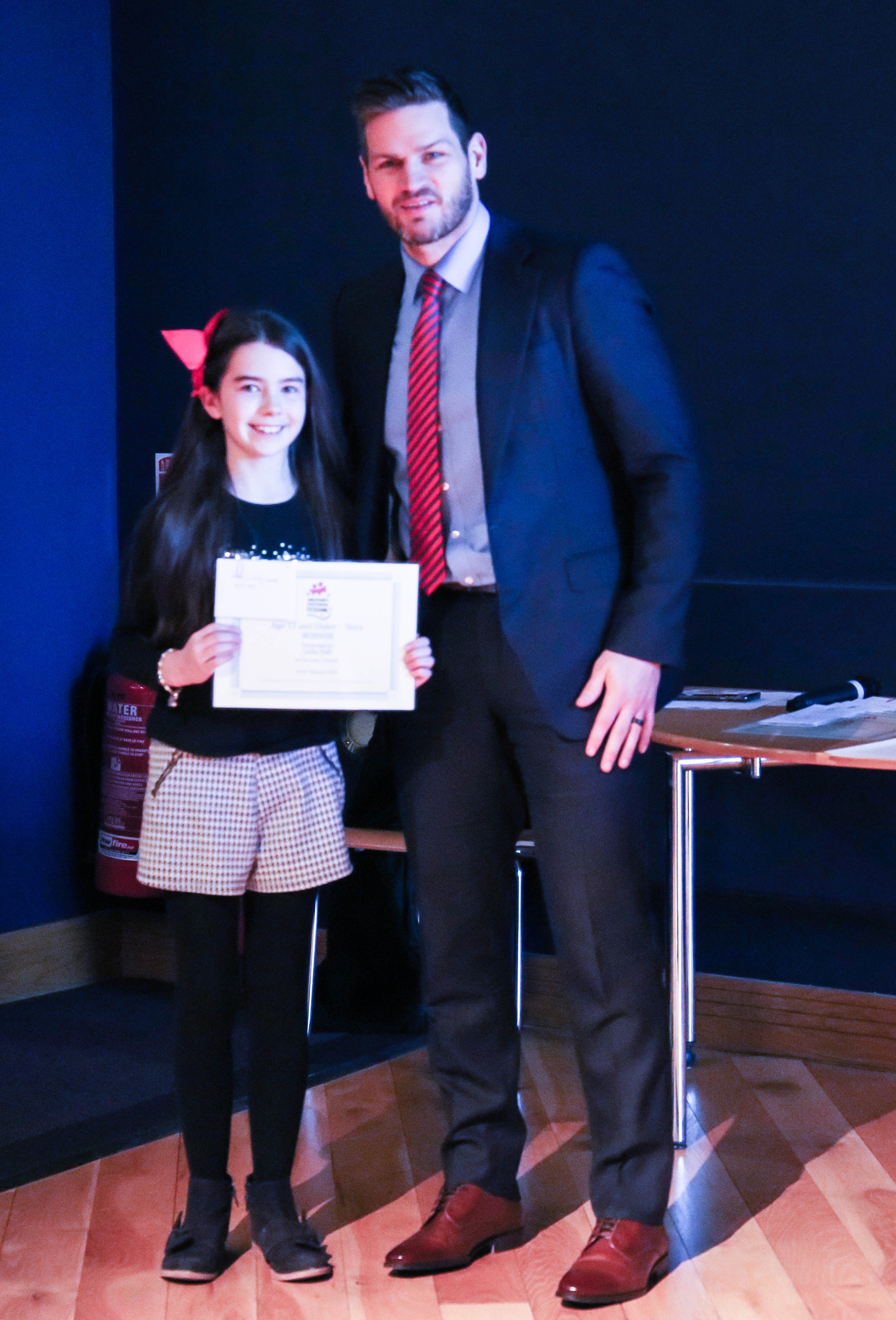 Leila Hall getting her winners certifiace from Adam Keefe manager of the Belfast Giants