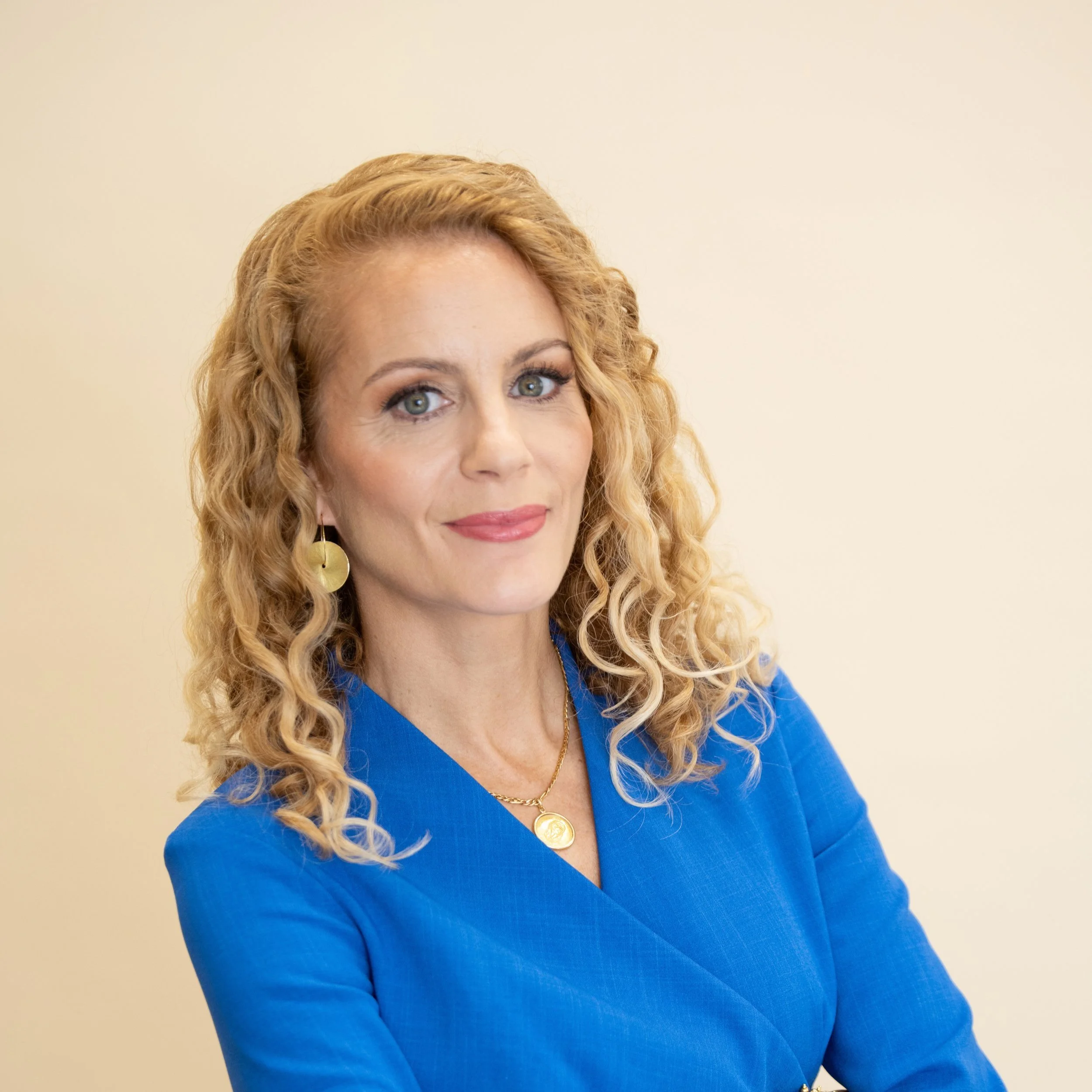 Women's Leadership Coach, Stephanie Aitken, smiles at the camera