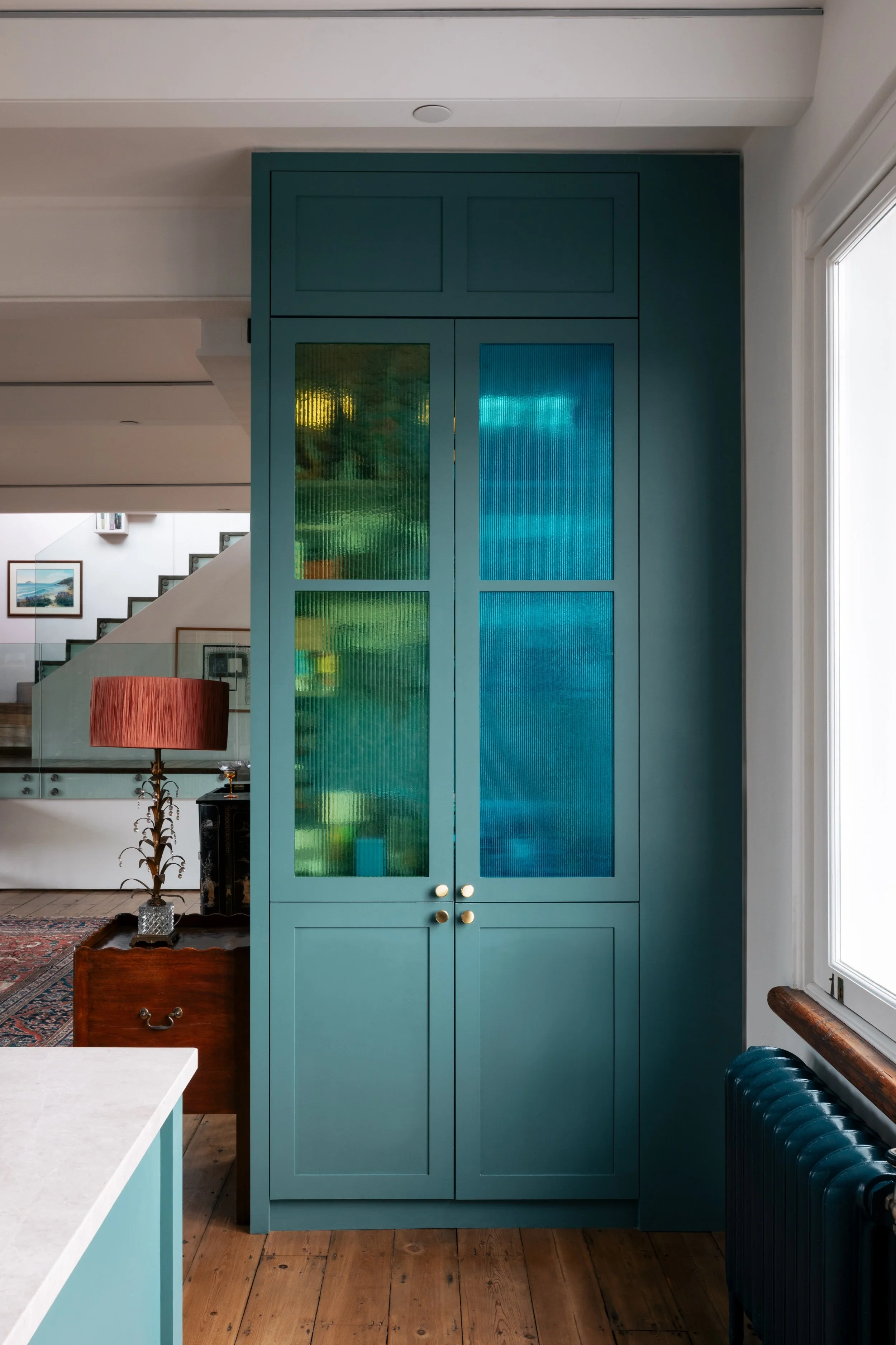 Interior view of a London home renovation highlighting architectural design services with natural light and crafted material palette