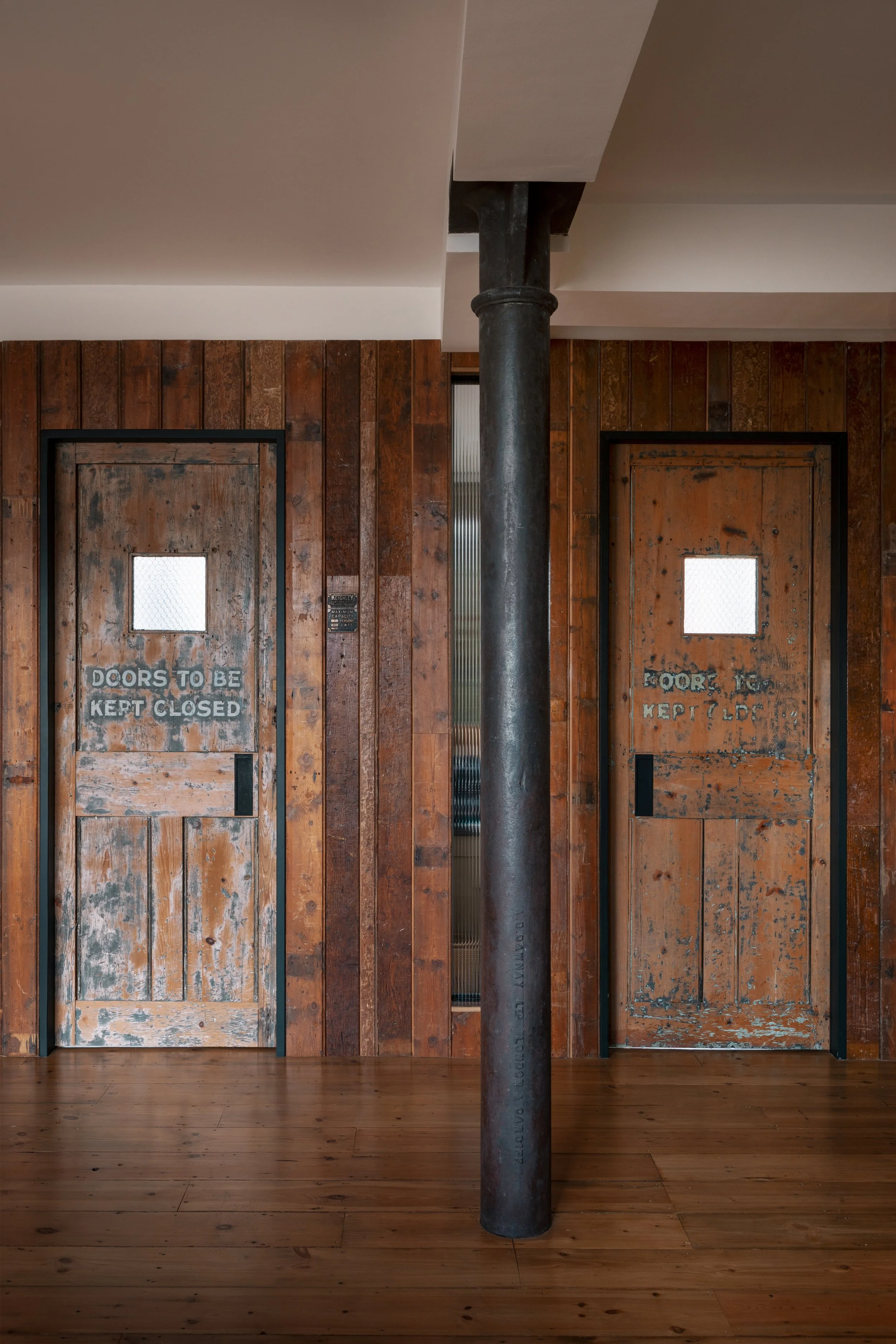 Residential urban home in Shoreditch, London, converted from a former factory with a reclaimed door by architecture and design studio Studio Tashima.