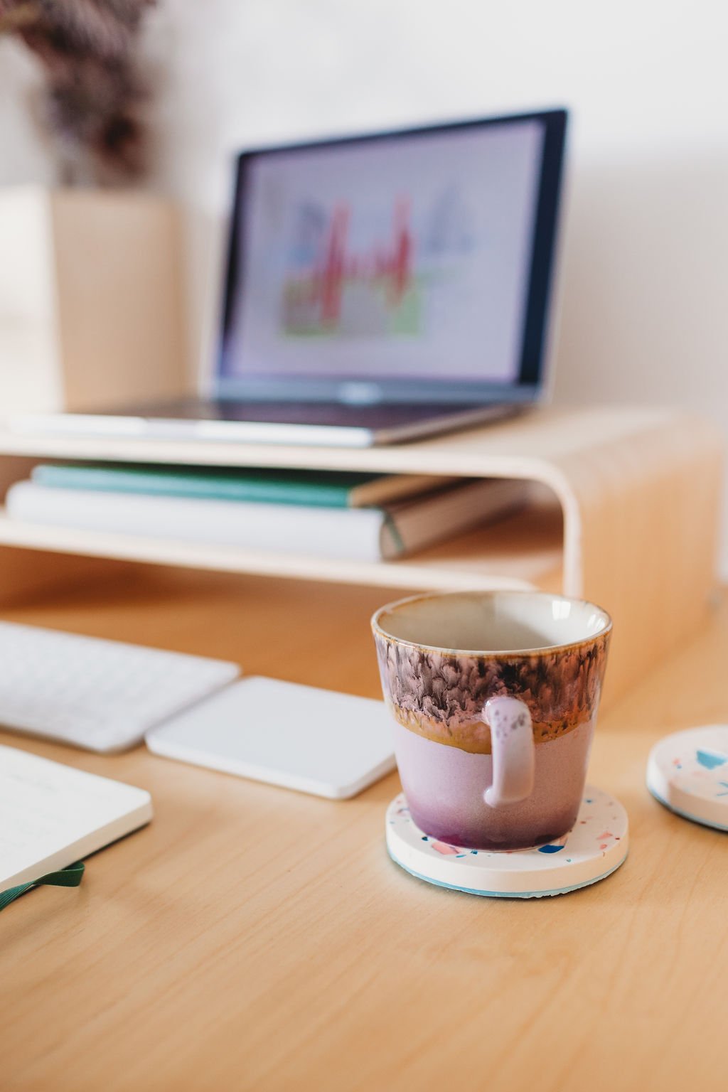 lilac mug of tea with laptop with architect drawing in background