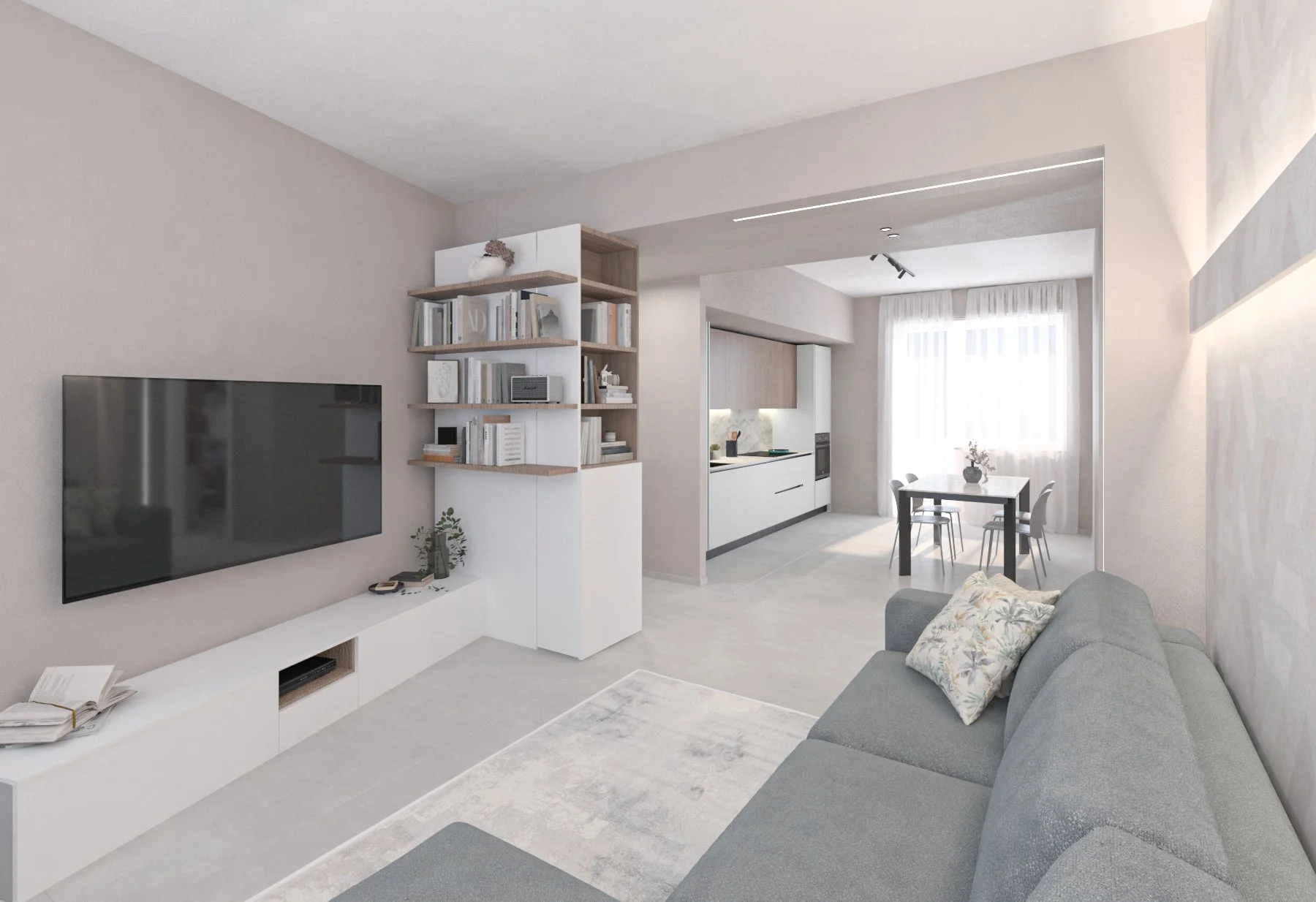 Interno di un soggiorno moderno con divano grigio, televisore a schermo piatto, scaffale con libri, pareti chiare, tavolo da pranzo con sedie e cucina in background