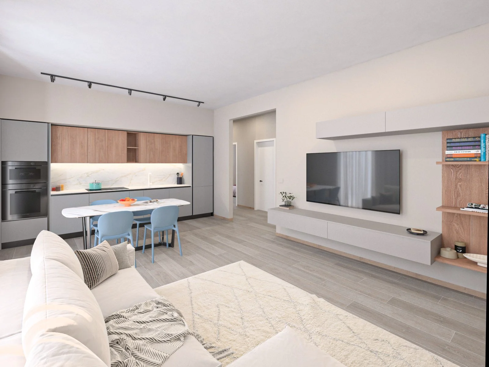 Interno di un soggiorno con cucina a vista, divano, televisore e scaffale in legno