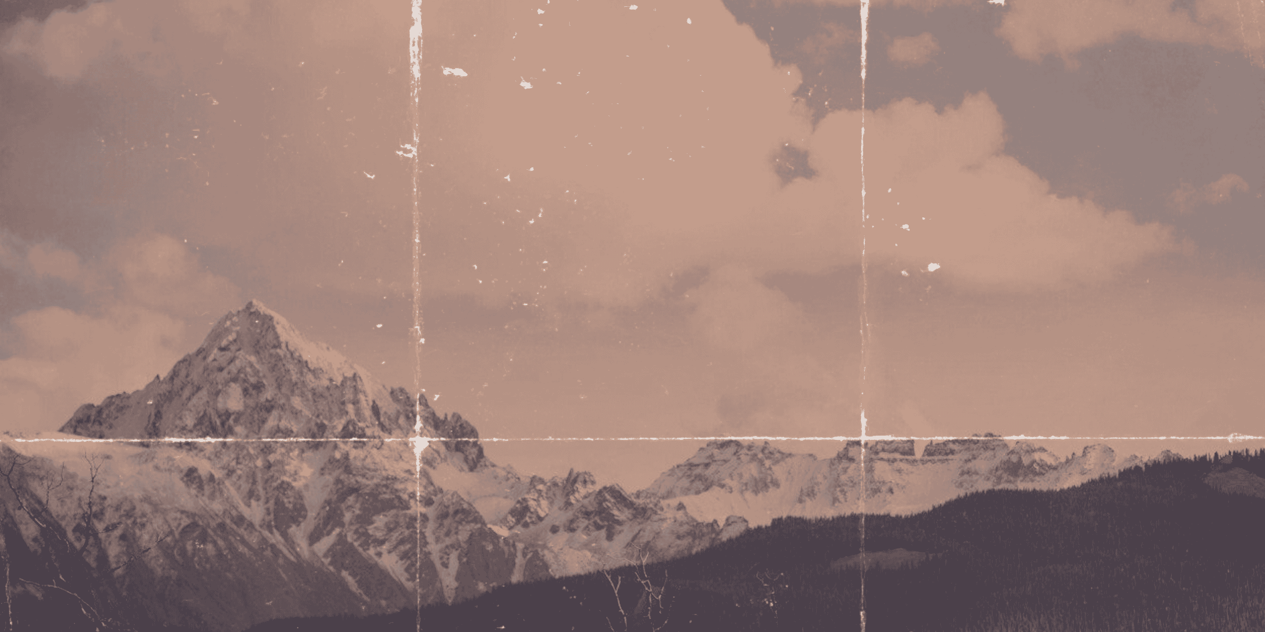 Mountains with snow-covered peaks under a cloudy sky, sepia-toned and with vintage-style scratches.