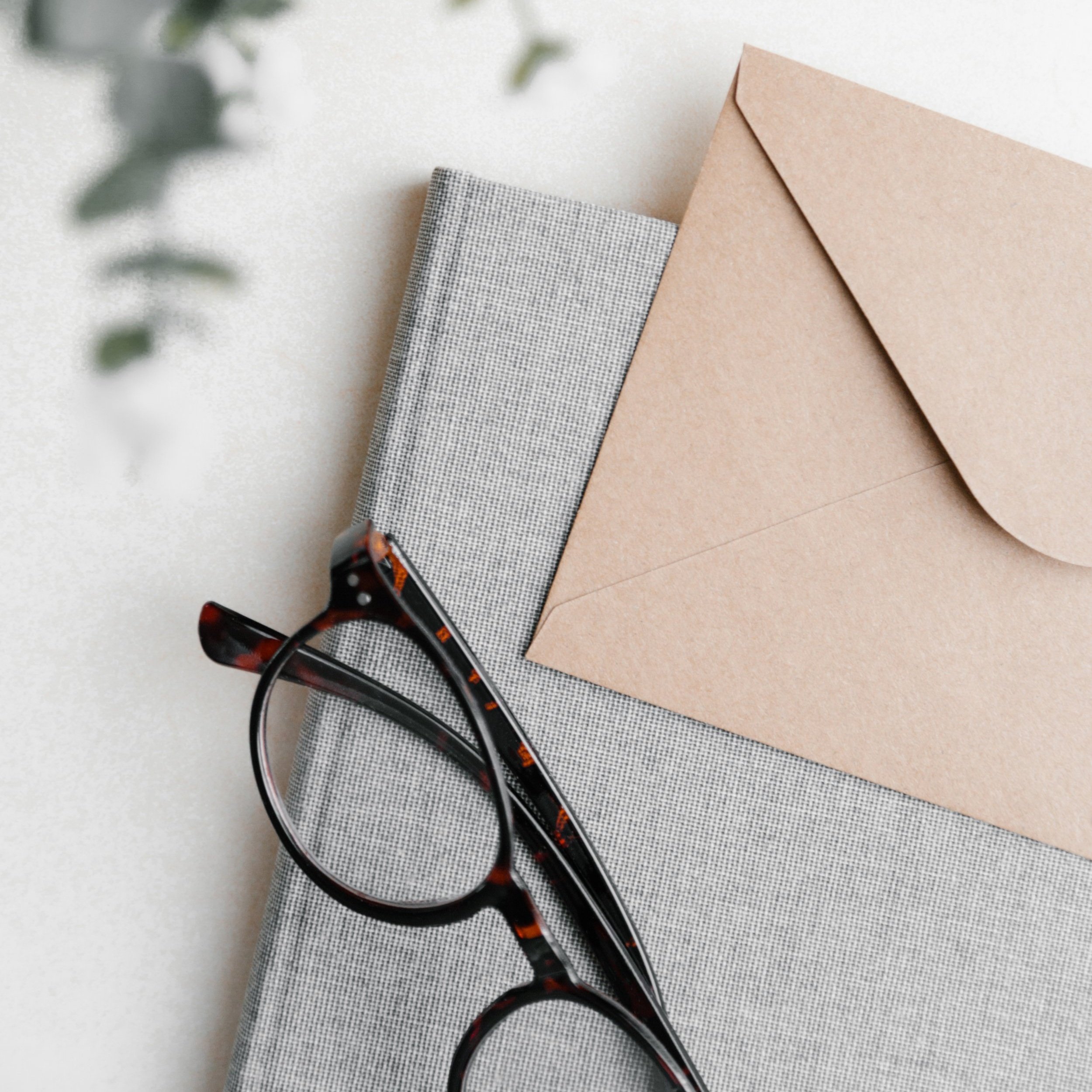 Glasses and envelope on book