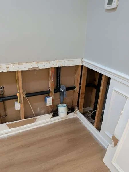 Wide view of opened wall along plumbing line, Vienna VA drain leak repair