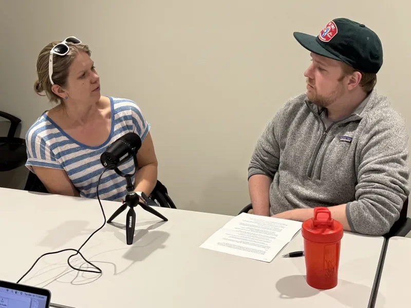 Regan Linton speaks into a microphone.