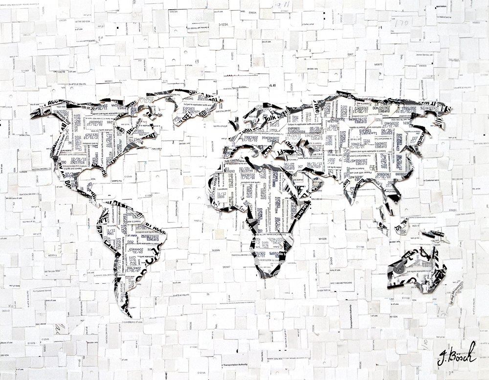 World map outlined with torn pieces of paper with printed text.