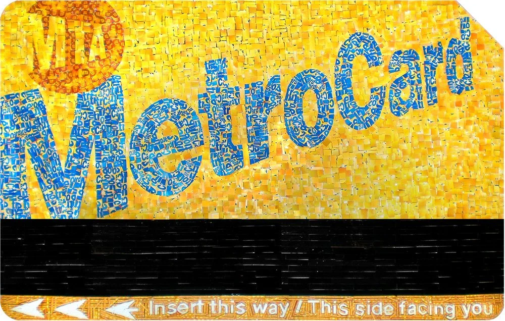Sign with the words "WE ARE OPEN" in blue text on a yellow mosaic background, with a black stripe and a message at the bottom that says "Insert this way / This side facing you".