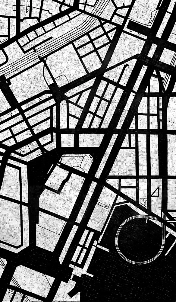 Black and white map showing streets, blocks, and a stadium in an urban area.