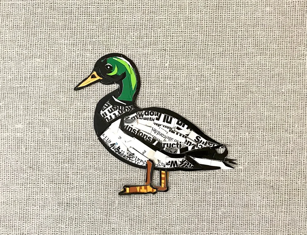 Collage art of a duck made from cut-out magazine and newspaper pieces placed on a textured beige background.