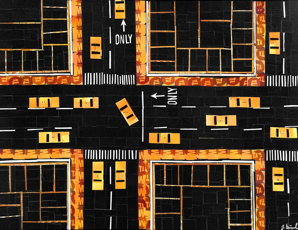 A miniature cityscape with toy cars, roads, and buildings, all made from construction paper and craft materials.