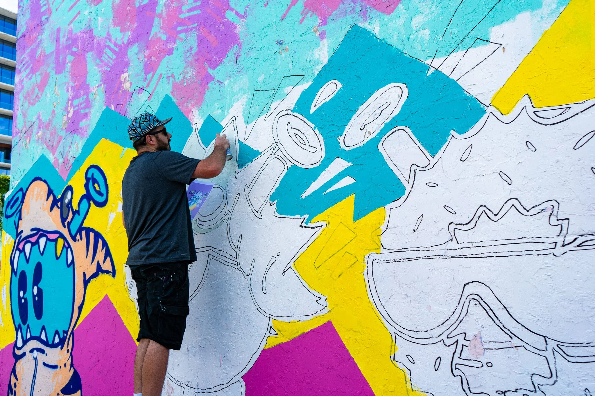 Miami Muralist Roc Sol painting Quirkies NFT Mural in Wynwood Street Art