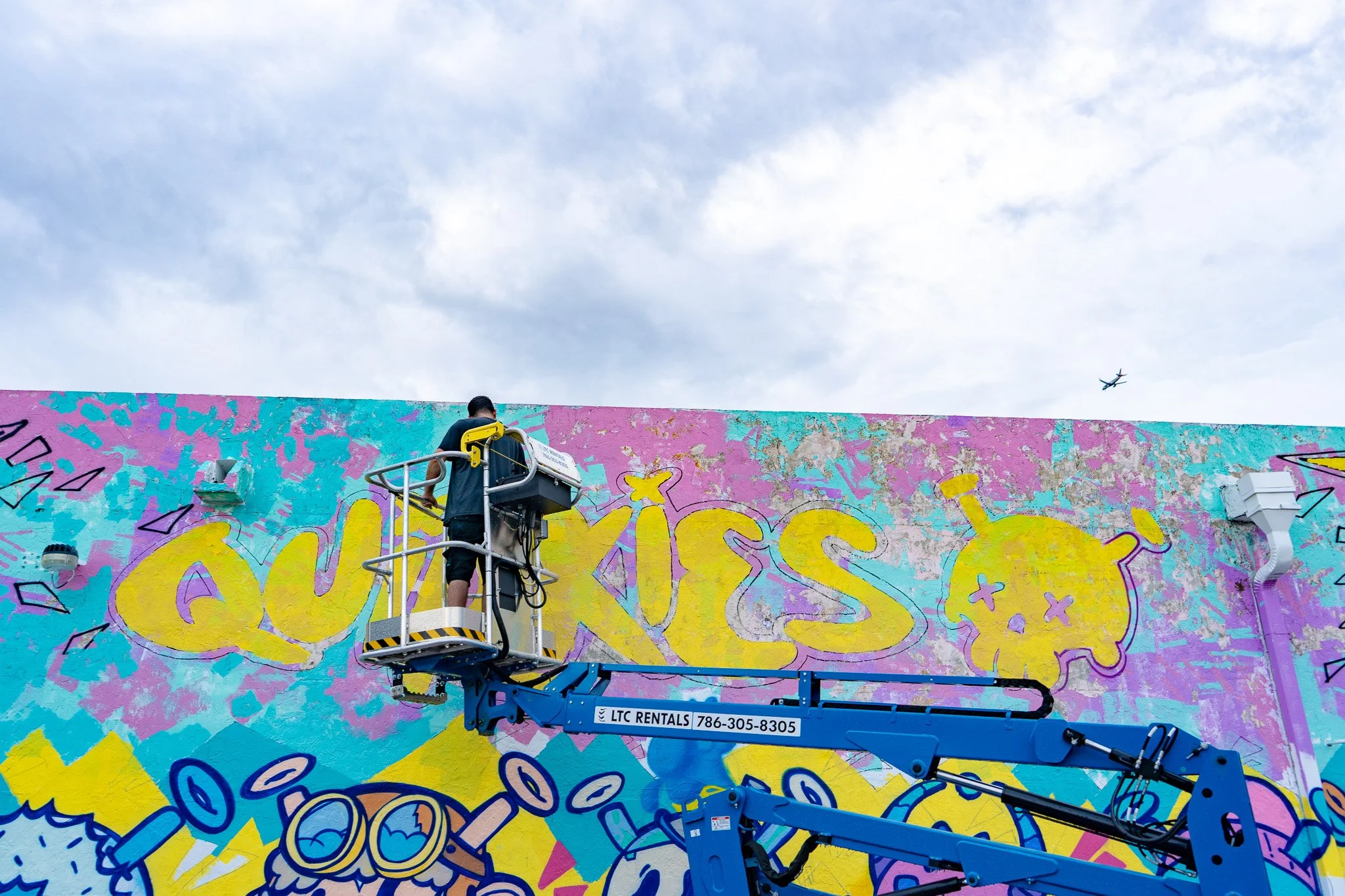Miami Muralist Roc Sol painting Quirkies NFT Mural in Wynwood Street Art