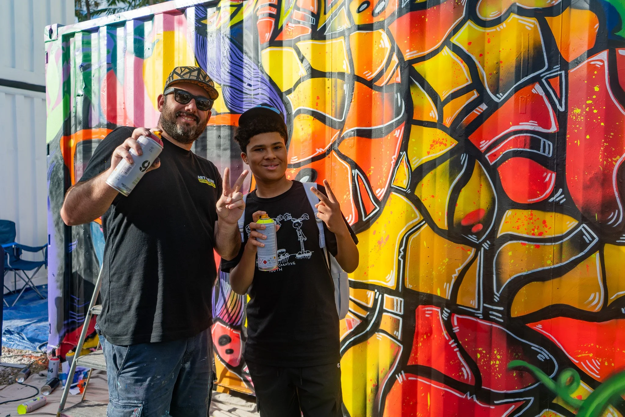 HIVE 2024 A cocktail art and culinary village in Wynwood Miami Art Week Live painting a Mural Container for Verizon Miami Art Week Art Basel Mural with Roc Sol Dee Perez and Miss Lushy with Project Roadmap Murals at The Wynwood Marketplace with DJ Fr