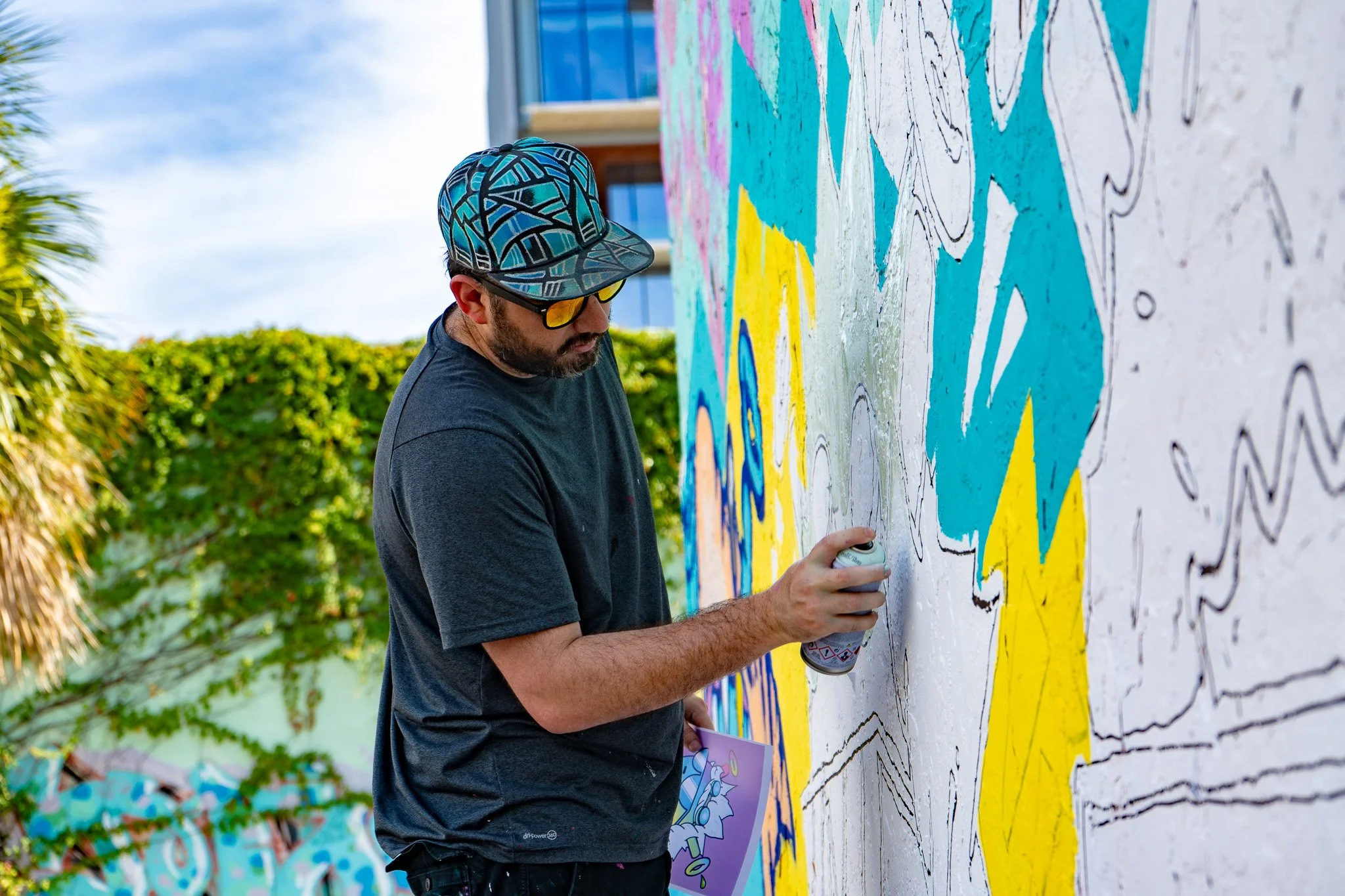 Miami Muralist Roc Sol painting Quirkies NFT Mural in Wynwood Street Art