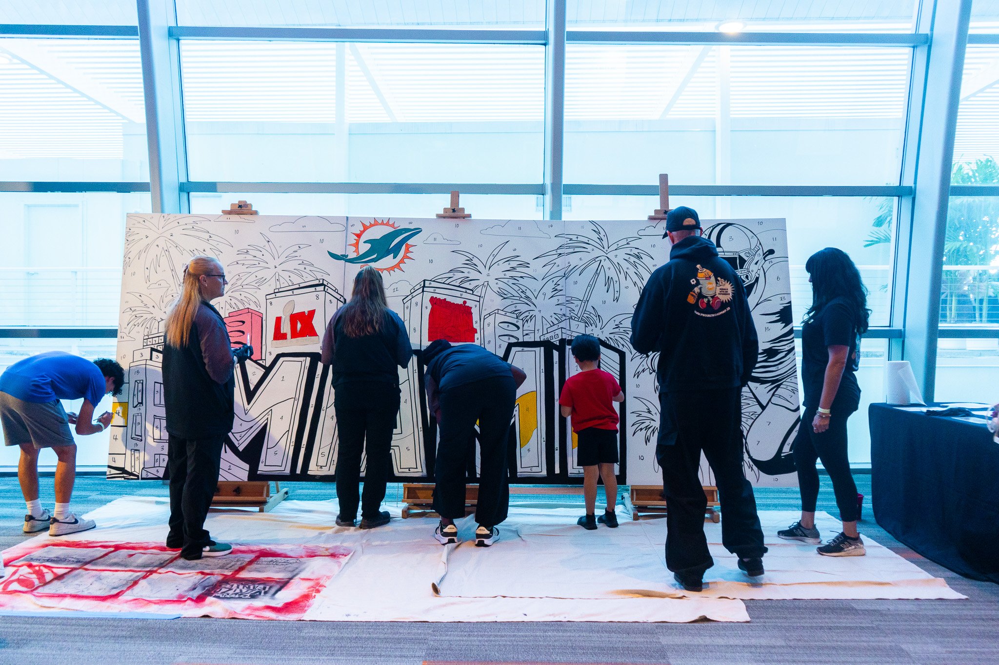 Paint by Numbers mural experience in Miami for the Super Bowl LIX Verizon FanFest Miami Dolphins by Roc Sol Project Roadmap Dee Perez Miss Lushy Miami muralist artist