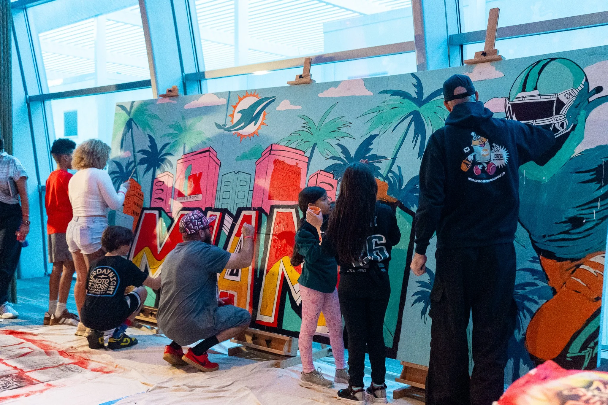 Paint by Numbers mural experience in Miami for the Super Bowl LIX Verizon FanFest Miami Dolphins by Roc Sol Project Roadmap Dee Perez Miss Lushy Miami muralist artist