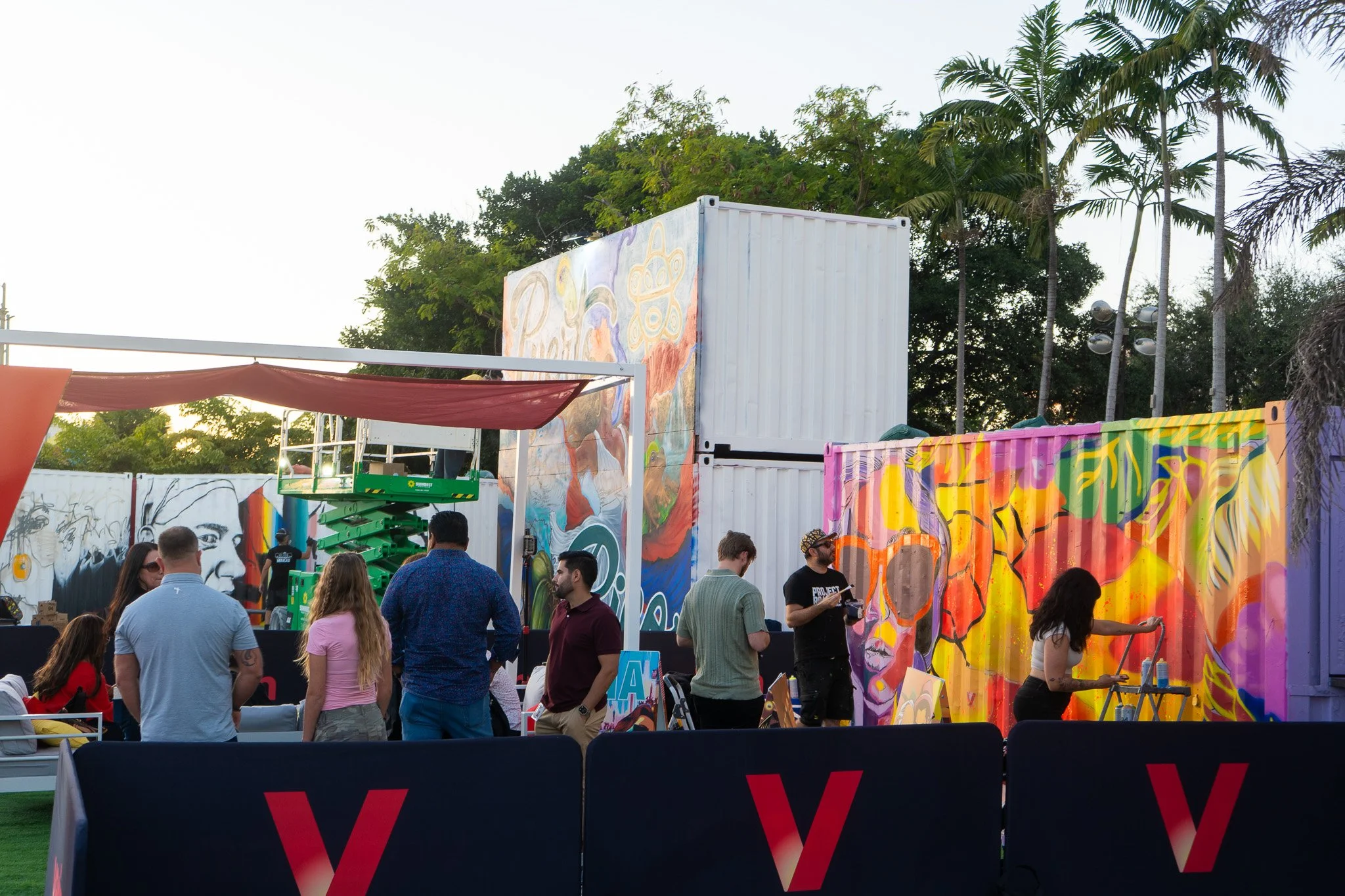 HIVE 2024 A cocktail art and culinary village in Wynwood Miami Art Week Live painting a Mural Container for Verizon Miami Art Week Art Basel Mural with Roc Sol Dee Perez and Miss Lushy with Project Roadmap Murals at The Wynwood Marketplace with DJ Fr