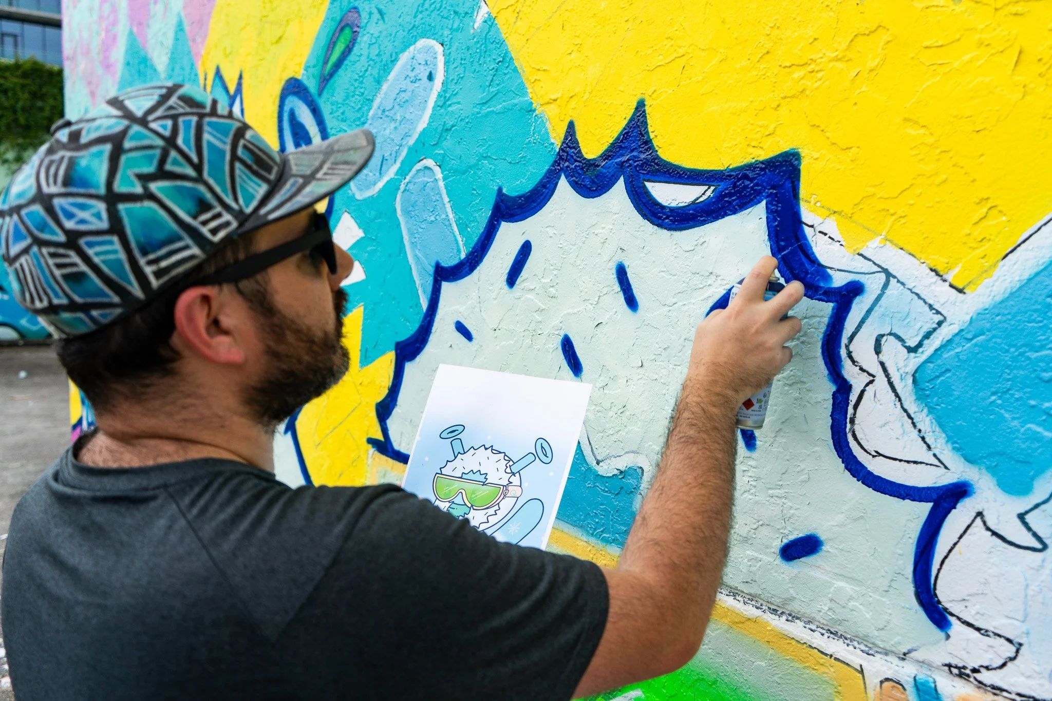 Miami Muralist Roc Sol painting Quirkies NFT Mural in Wynwood Street Art