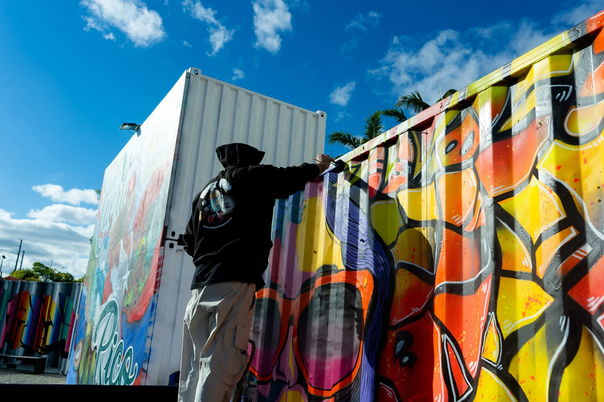HIVE 2024 A cocktail art and culinary village in Wynwood Miami Art Week Live painting a Mural Container for Verizon Miami Art Week Art Basel Mural with Roc Sol Dee Perez and Miss Lushy with Project Roadmap Murals at The Wynwood Marketplace with DJ Fr