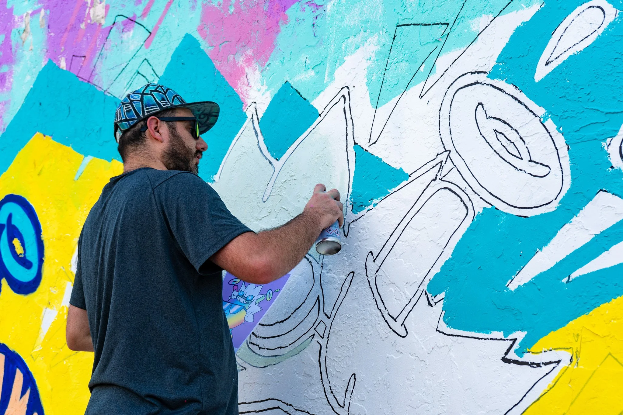 Miami Muralist Roc Sol painting Quirkies NFT Mural in Wynwood Street Art