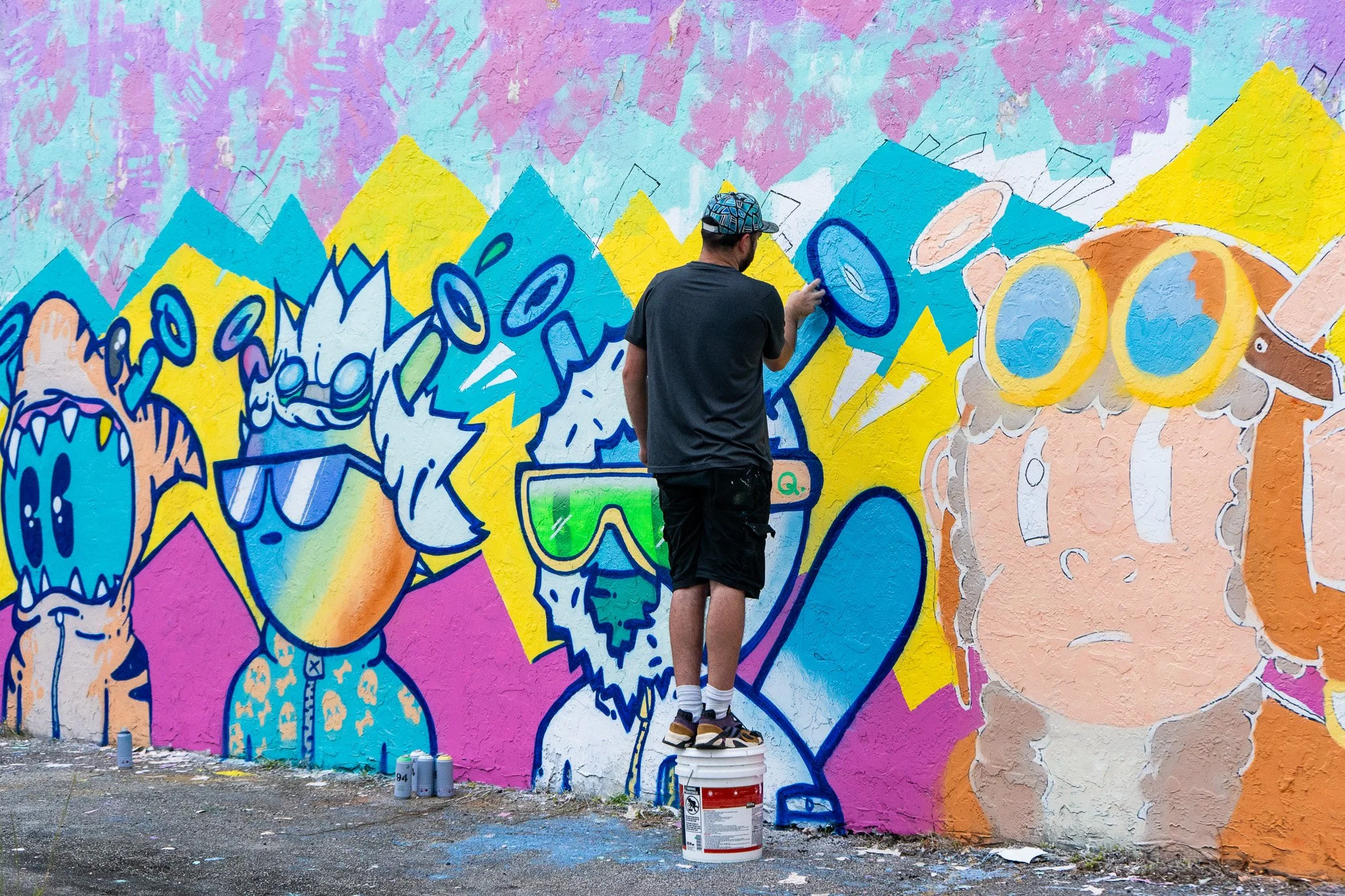 Miami Muralist Roc Sol painting Quirkies NFT Mural in Wynwood Street Art