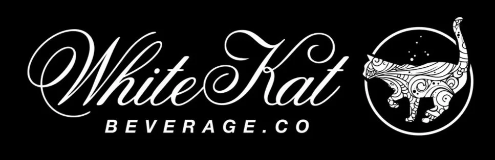 Logo for White Kat Beverage Co. with stylized text and a drawing of a patterned cat inside a circle.